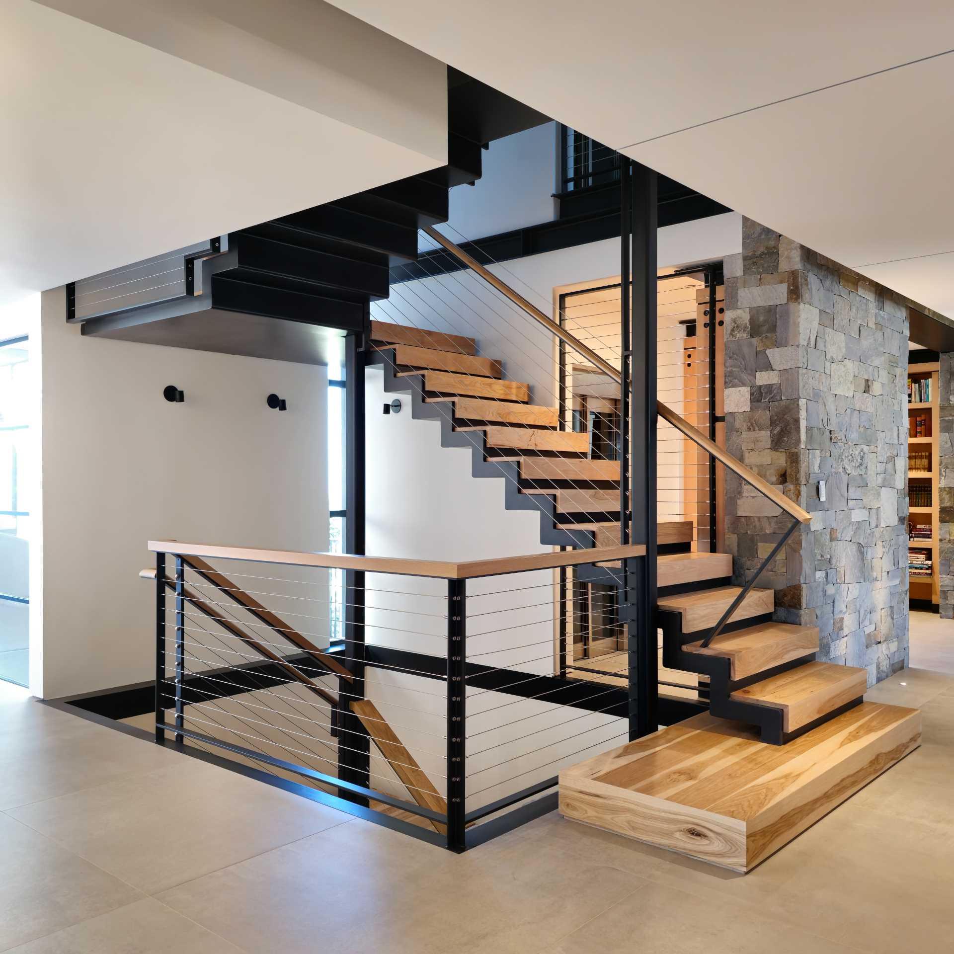 A modern home with steel and wood stairs.
