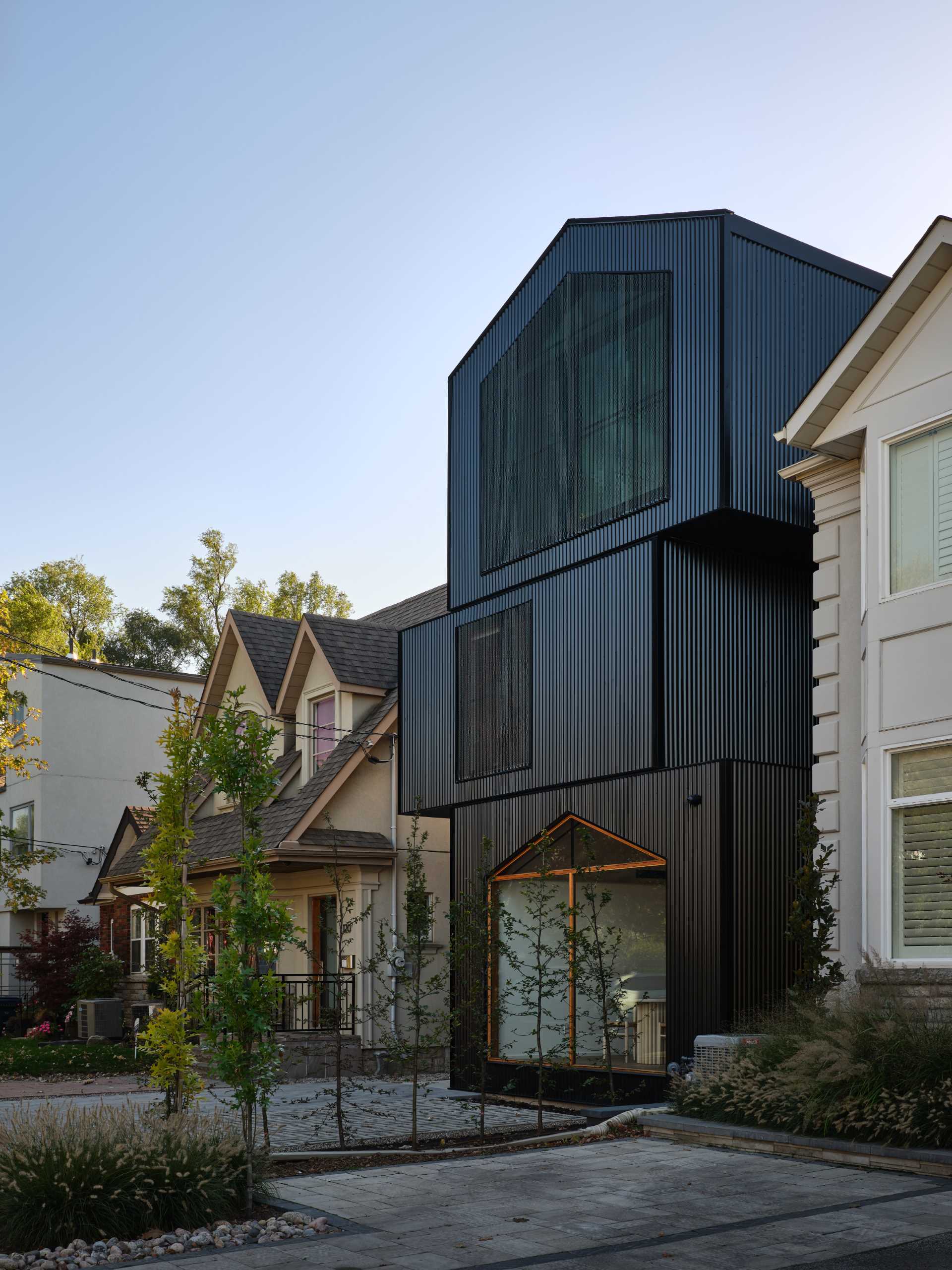 The home has a gable roof and appears as a series of stacked black boxes, with different levels defining the various areas of the home.