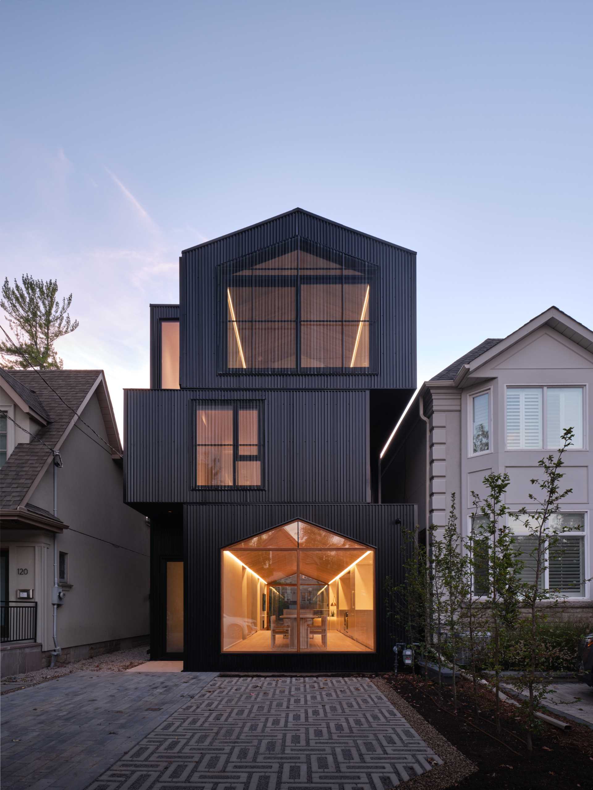 The home has a gable roof and appears as a series of stacked black boxes, with different levels defining the various areas of the home.