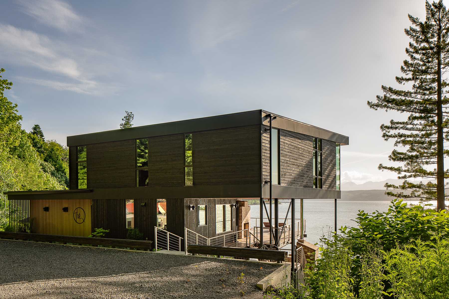 A modern beach house with black-stained and natural cedar siding.