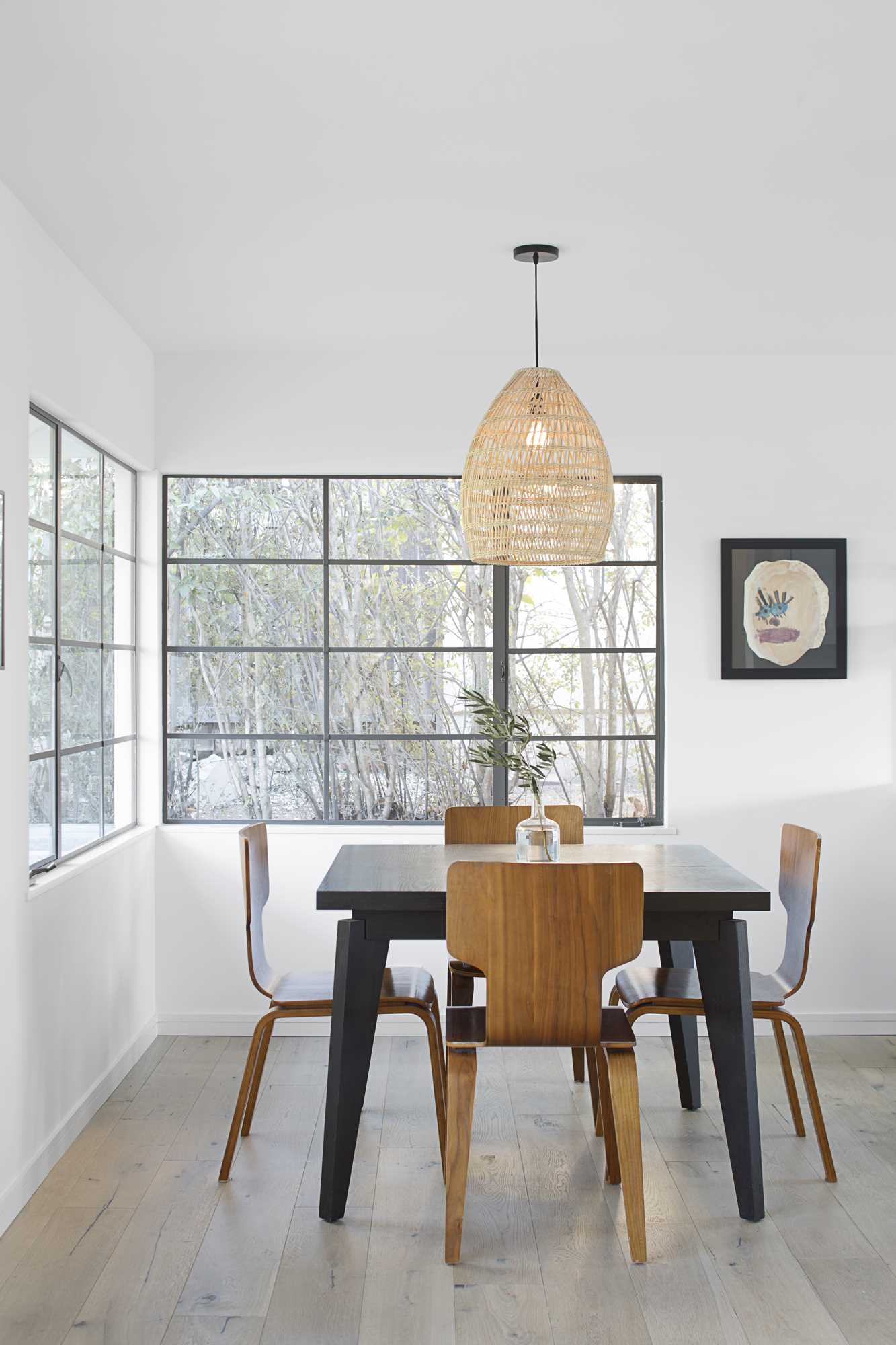 A modern dining room with windows that flood the interior with natural light.