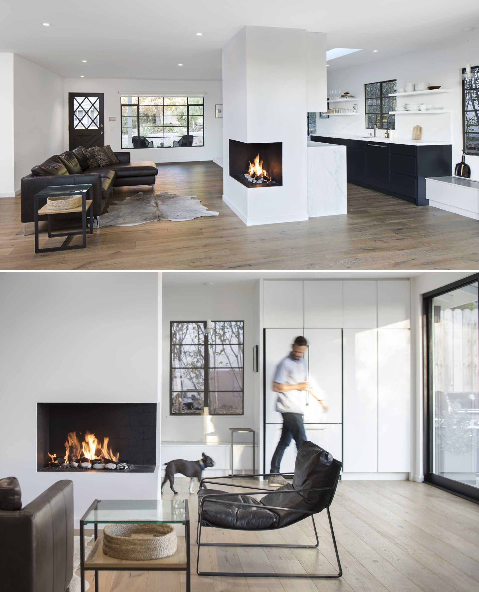 The interior of this renovated ranch home is inspired by Scandinavian design, with white finishes and cool woods used to create minimal space, which can be seen in the living room that also includes a fireplace.