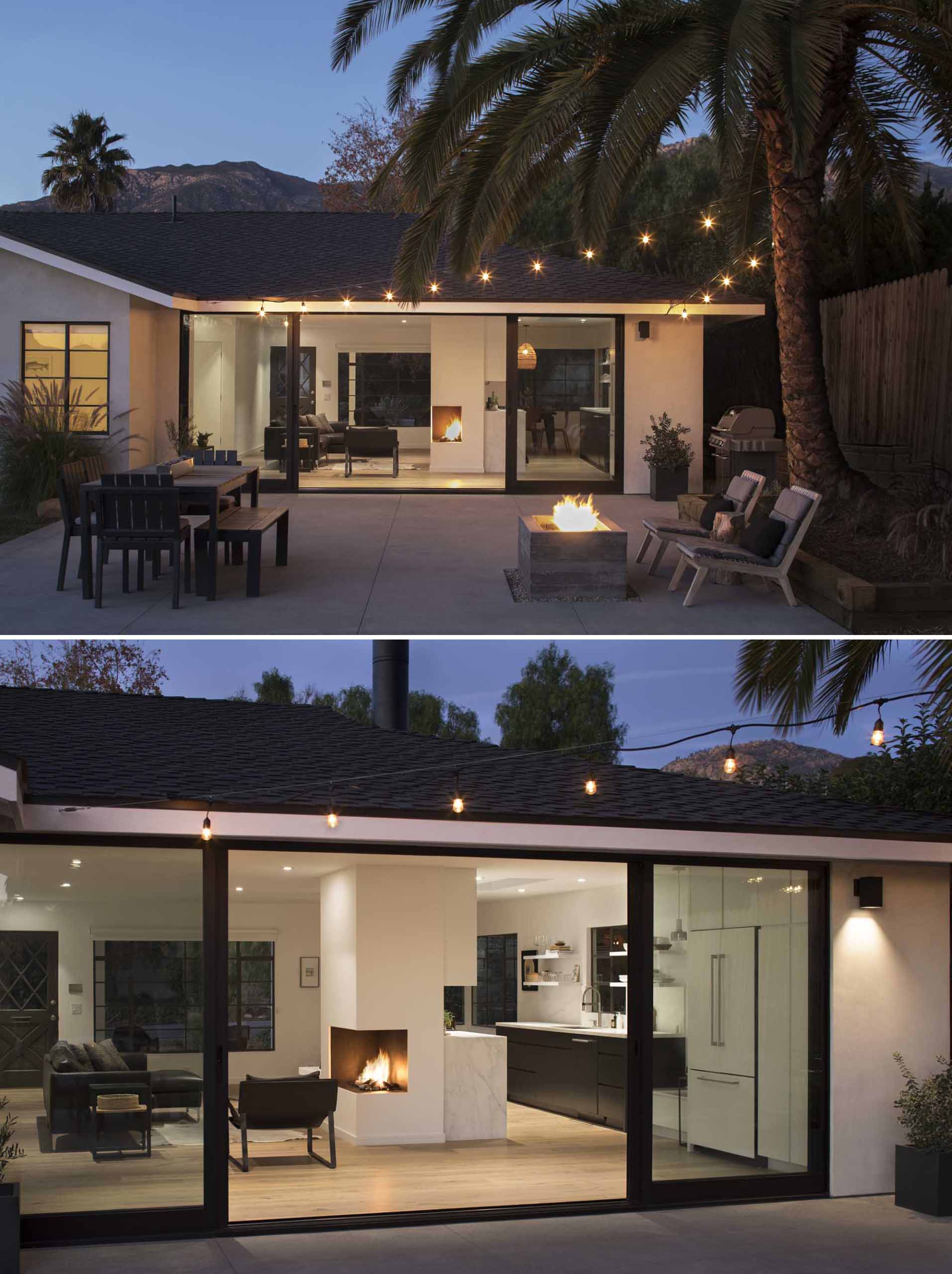 A new, large glass sliding wall now leads out to the rear yard, where there's a patio with outdoor dining, a BBQ, and a fire pit. String lights help to create an ideal outdoor entertaining area.