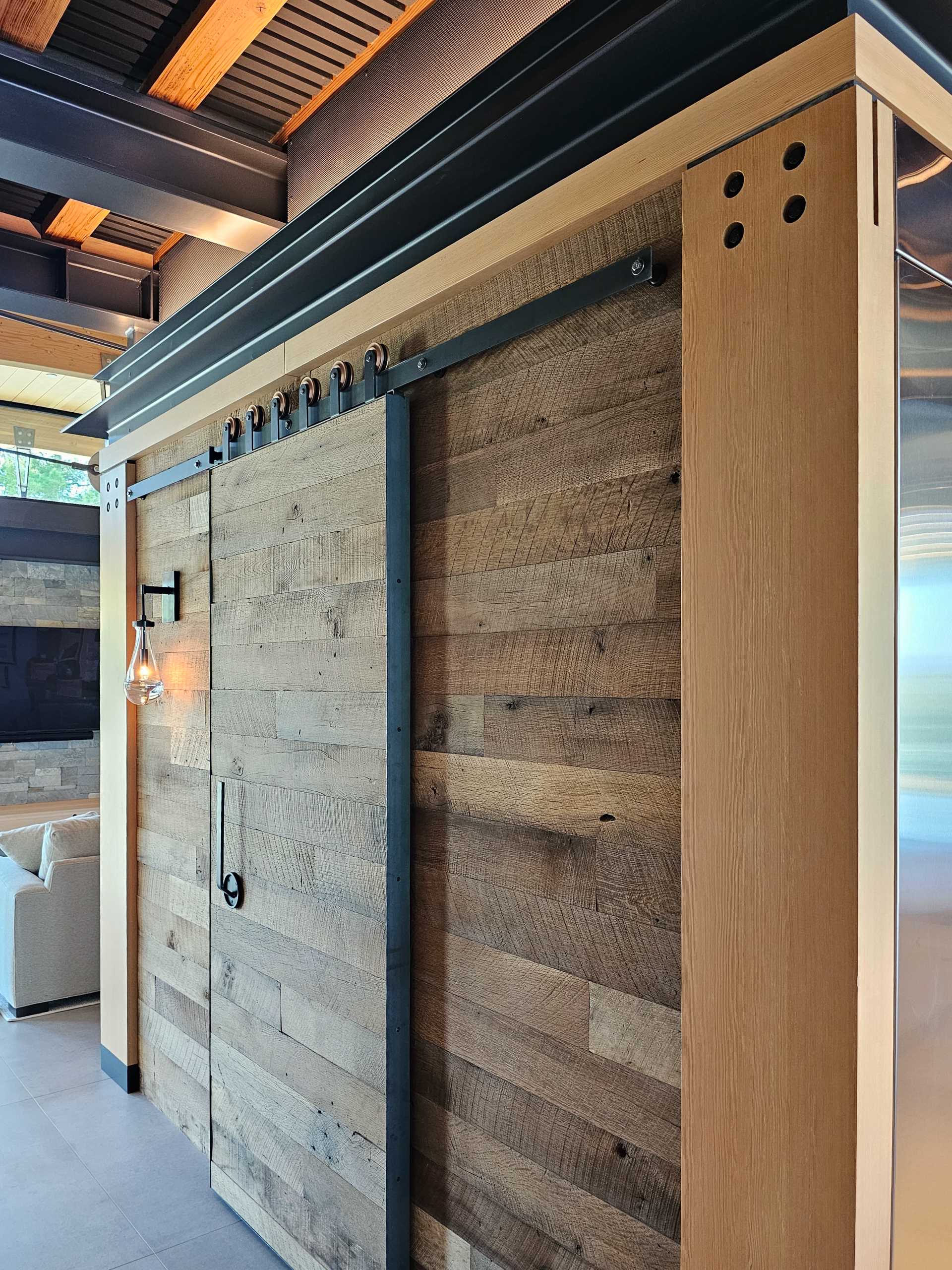 A kitchen with a pantry hidden from view behind a sliding door.