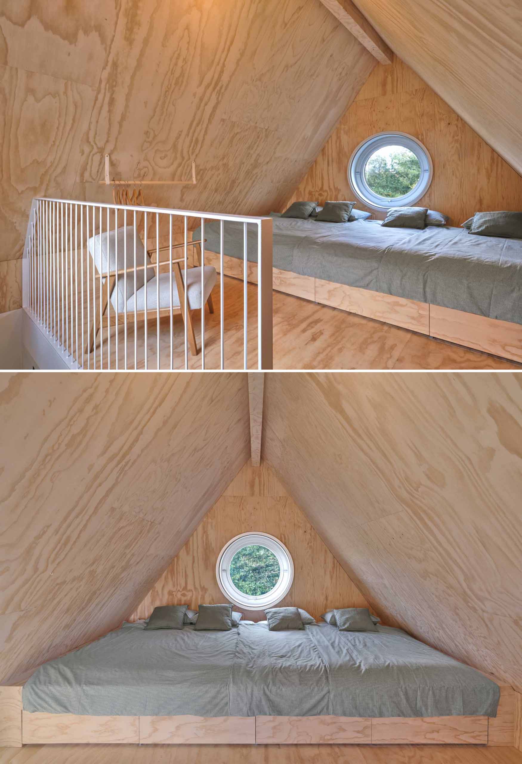 The sleeping area of a small elevated cabin.