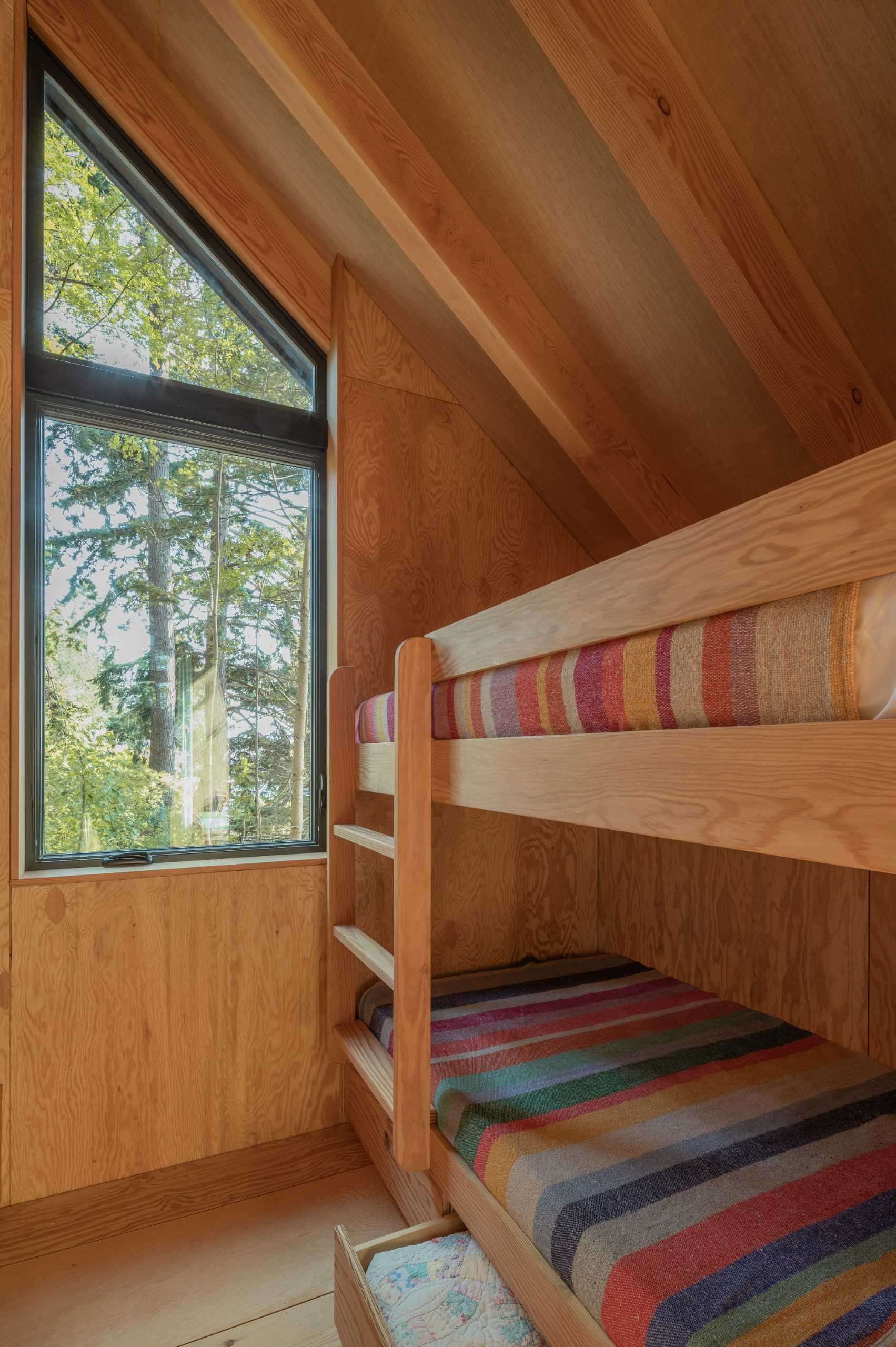 The bedrooms in this cabin are located on either side of the lounge area, with both bunk beds and regular beds. Curtains can be drawn to provide privacy when needed.