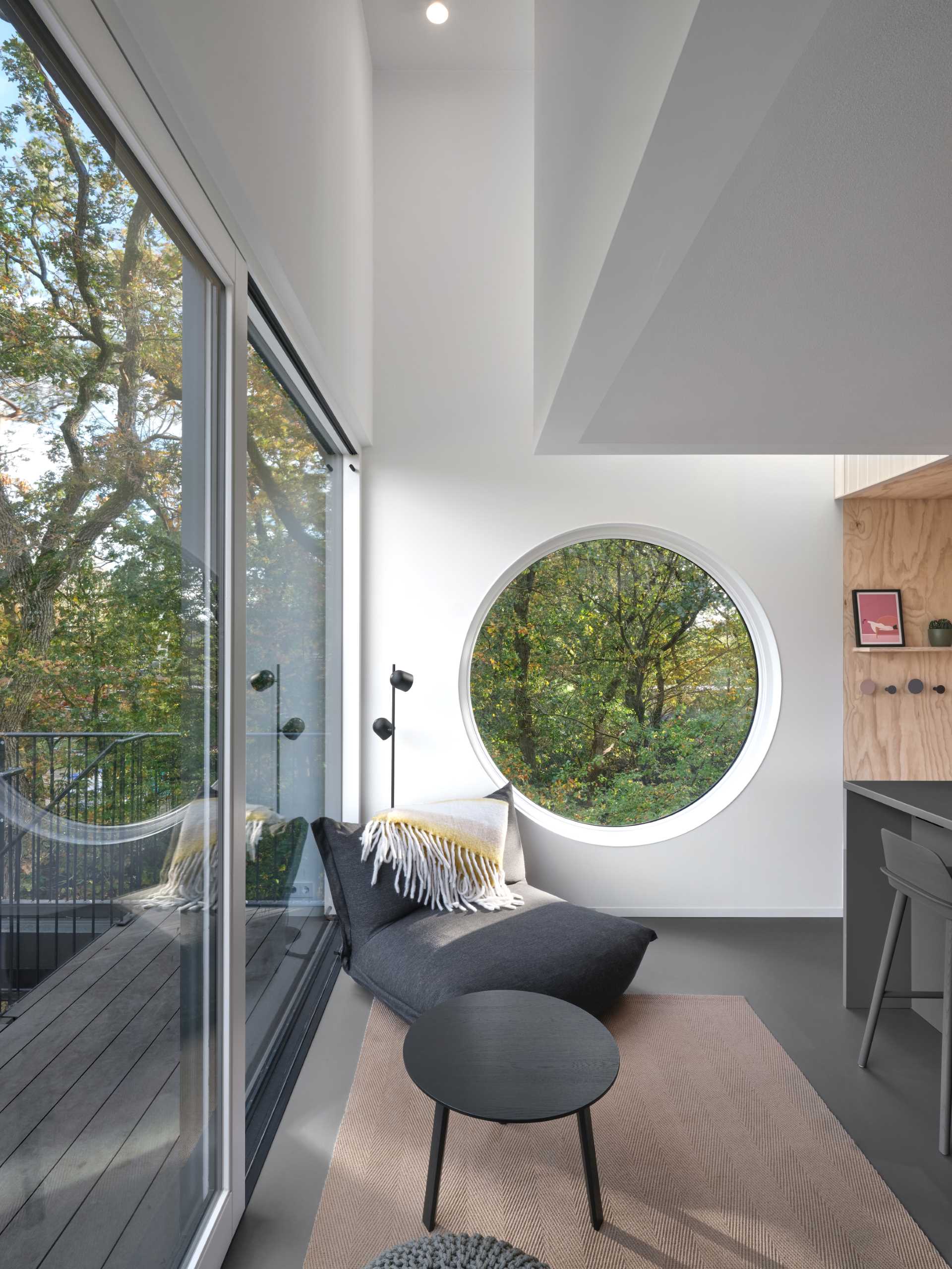 The living room and kitchen of a small elevated cabin.