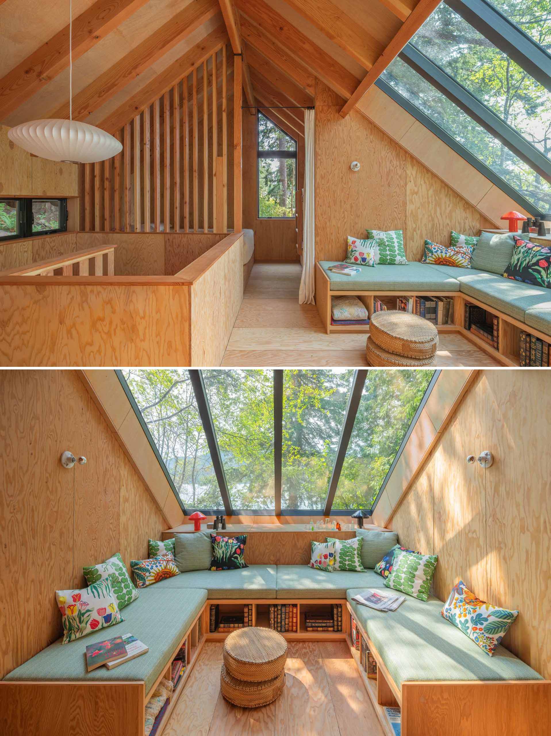 At the top of the stairs in this cabin, there's an open lounge area beneath custom skylights. Custom furniture with open storage underneath is topped with upholstered cushions, creating a cozy lounge.