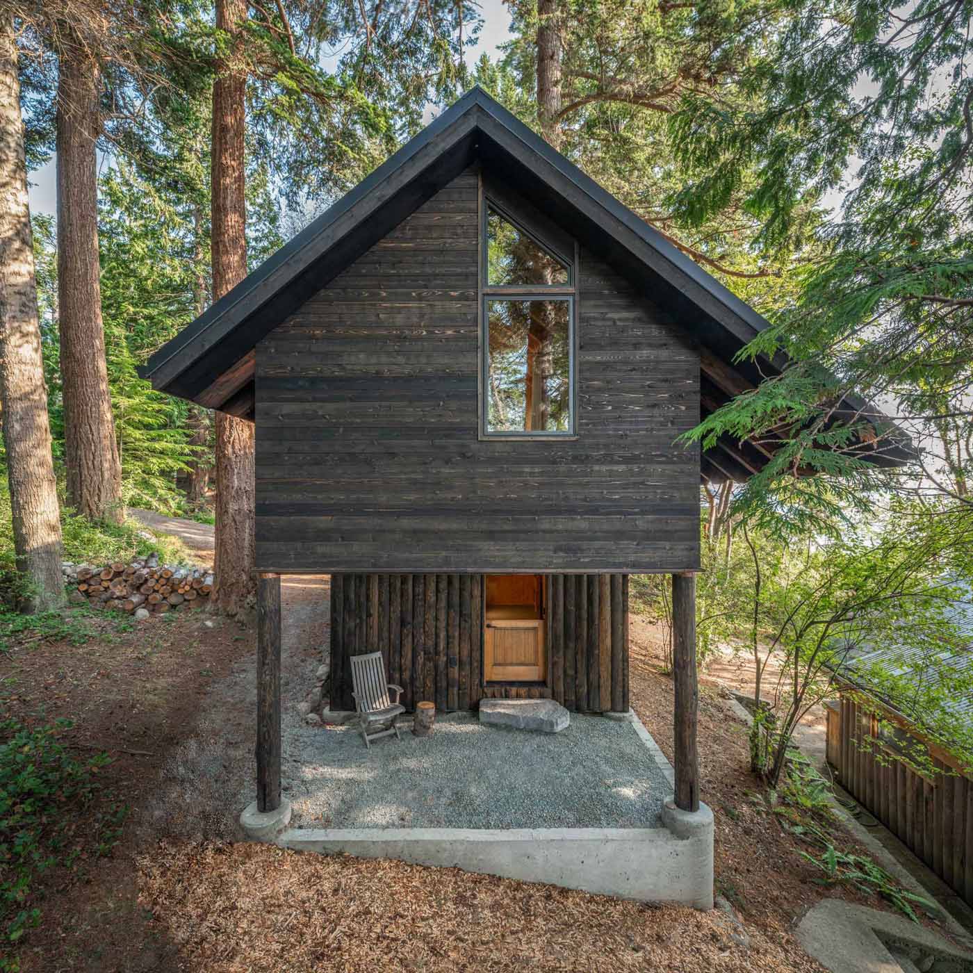 The exterior of the cabin features tongue and groove rough-sawn Western Red Cedar cladding, while the lower section has Disdero Cabin Log Siding. Both of which have been stained black.