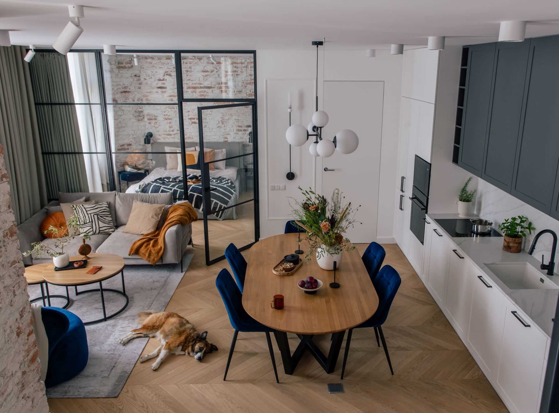 A modern two-storey apartment with a glass-enclosed bedroom.