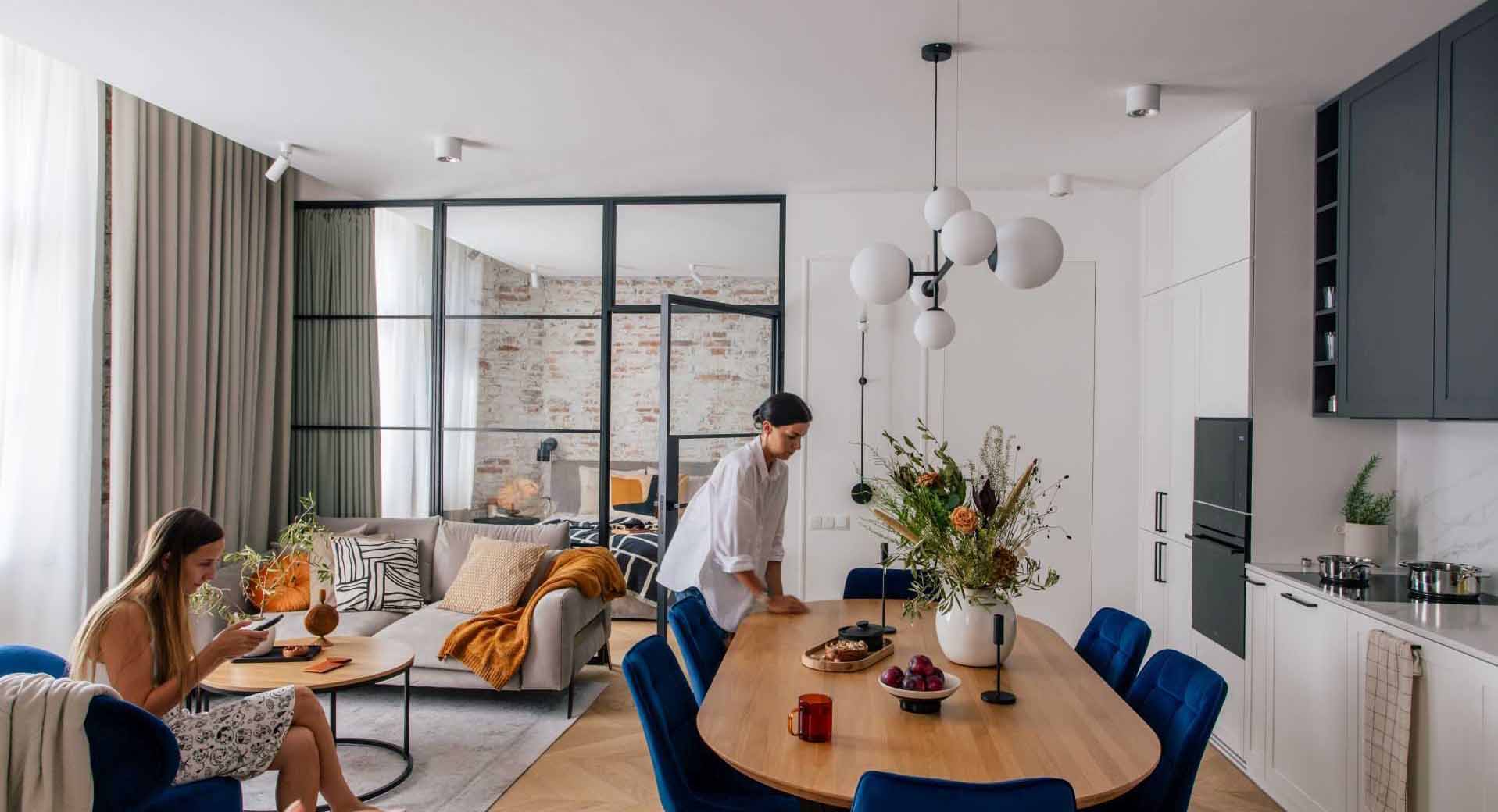 A modern two-storey apartment with a glass-enclosed bedroom.