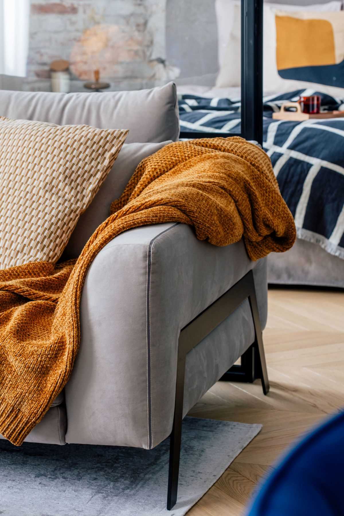 Burnt orange accents, like in this living room, can also be seen throughout the interior of this modern apartment.