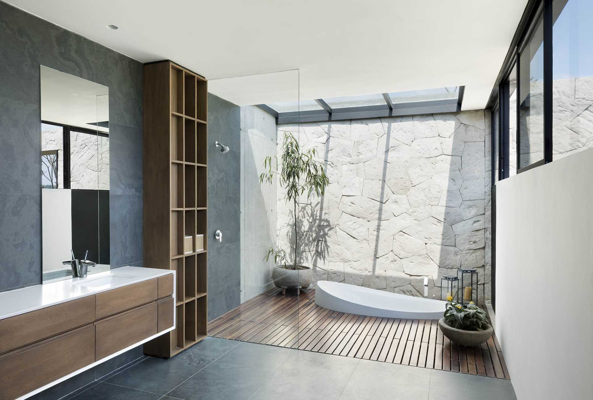 A modern bathroom with a sunken bathtub.