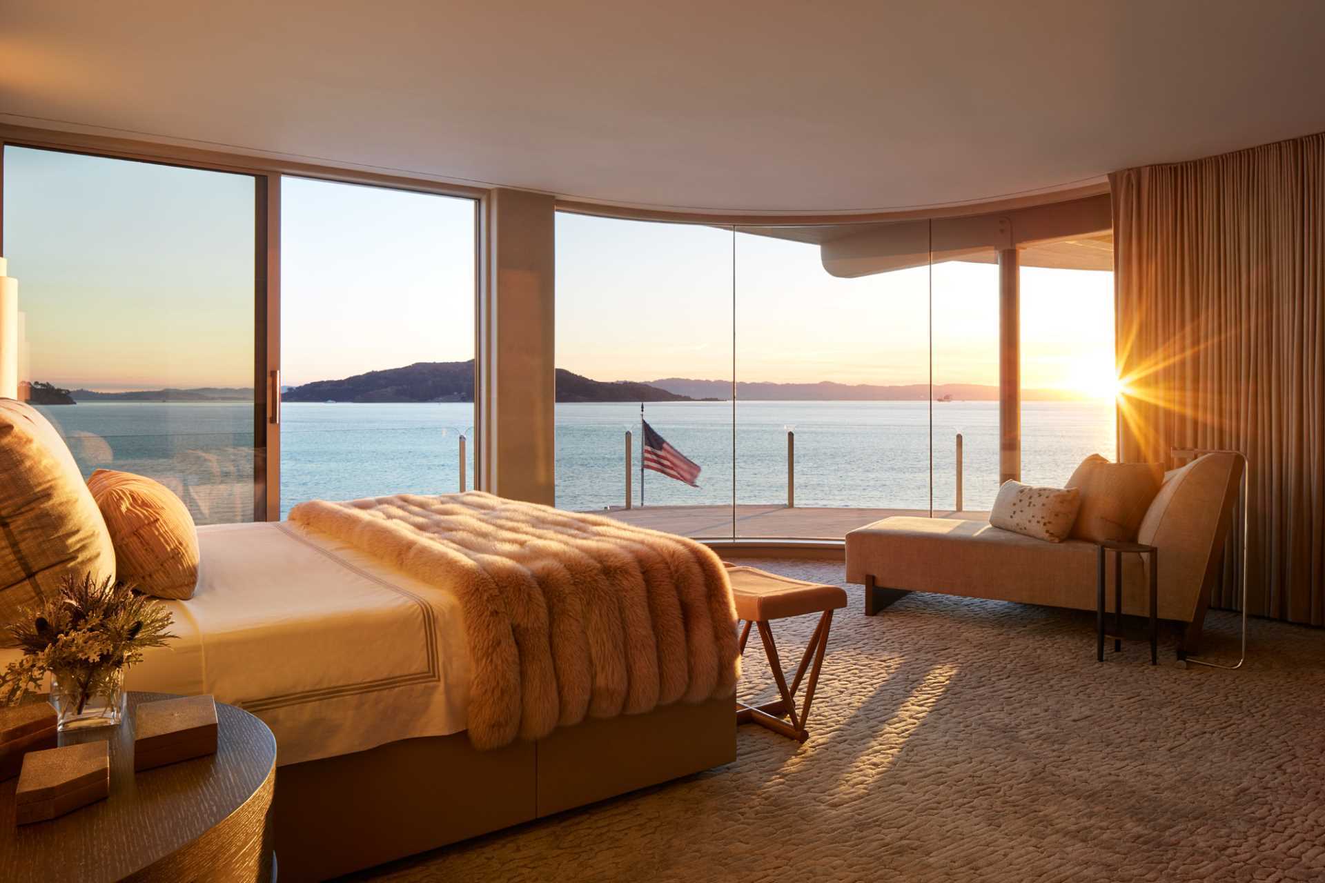 A modern bedroom with curved windows.