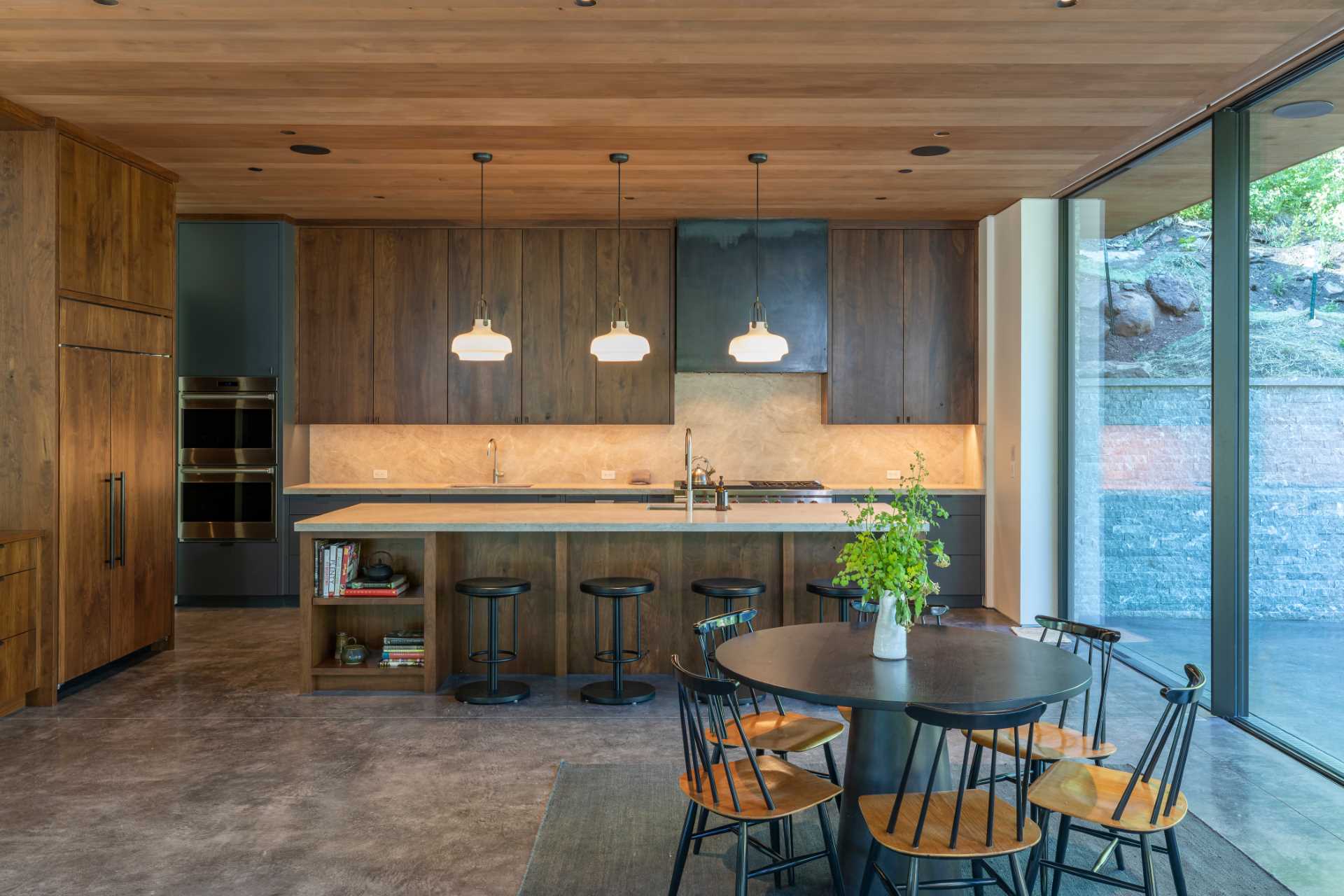 This modern kitchen features dark wood cabinetry with an island.