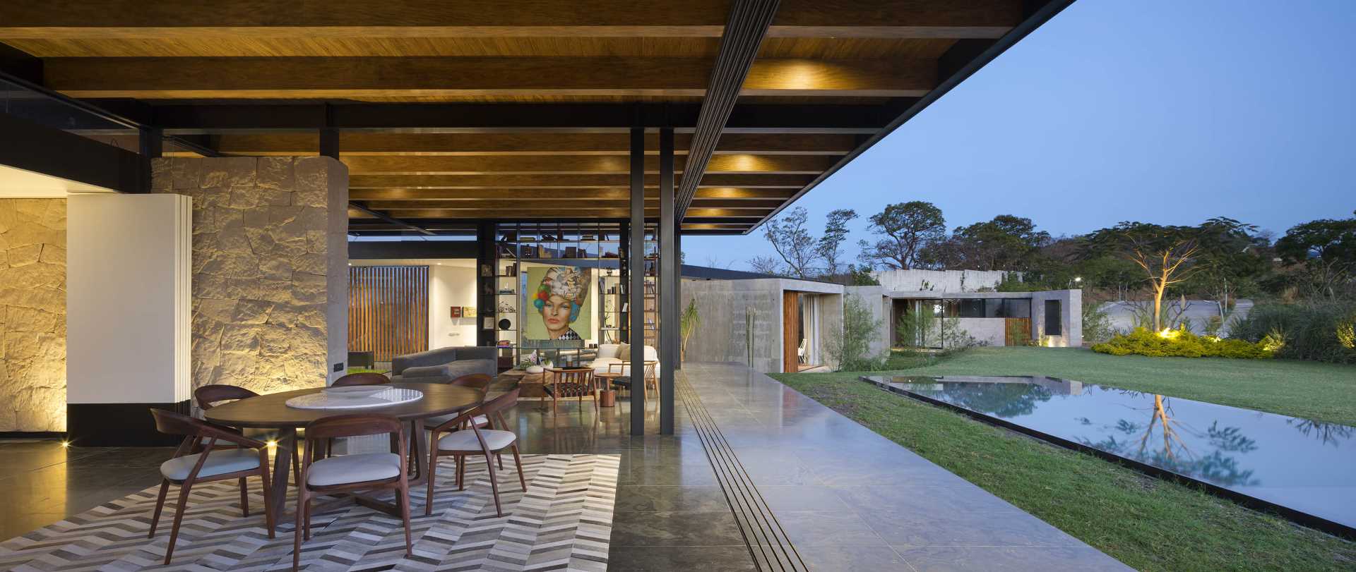 A modern dining room that opens to the outdoors and swimming pool.