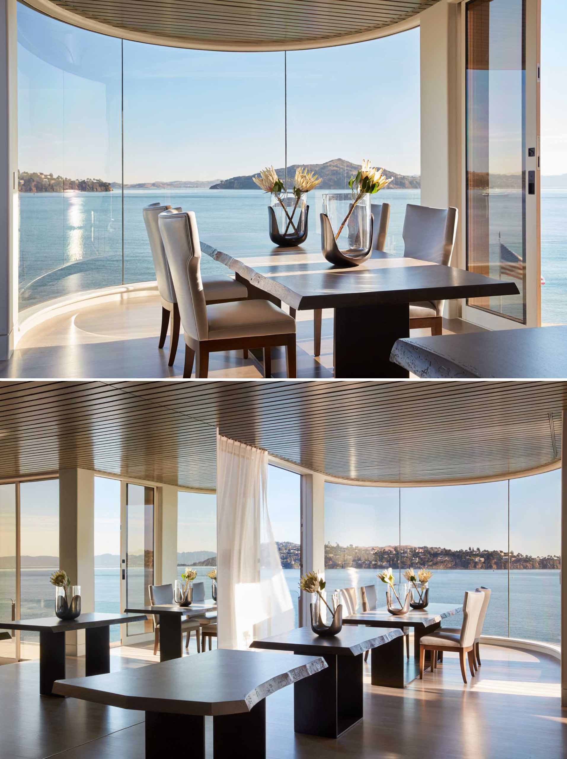 The curved floor-to-ceiling windows in this dining room act showcase the view, while a mirror makes the room feel larger.