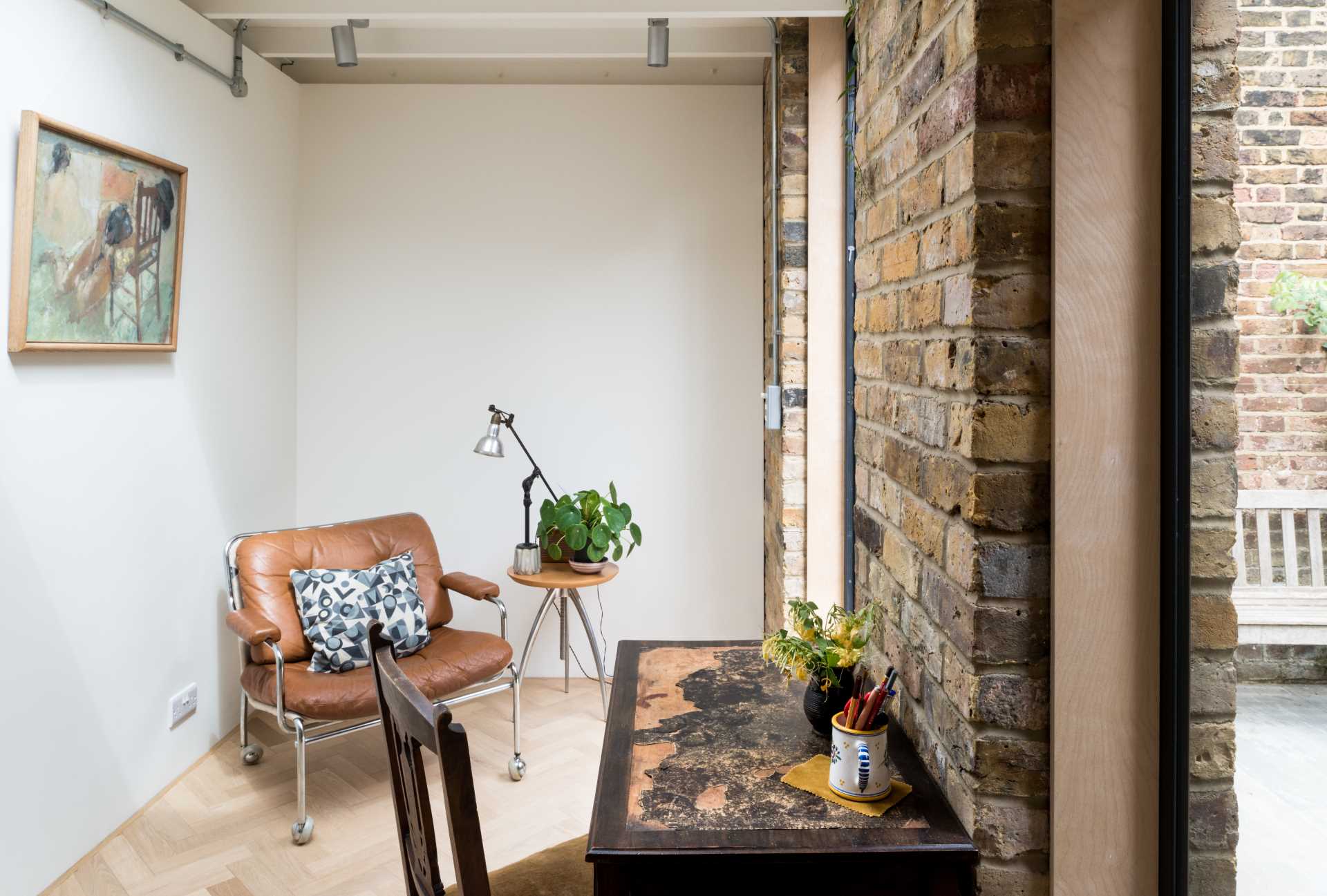 A new garden studio for a writer that includes a green roof, sitting area, built-in shelving, and a bathroom.