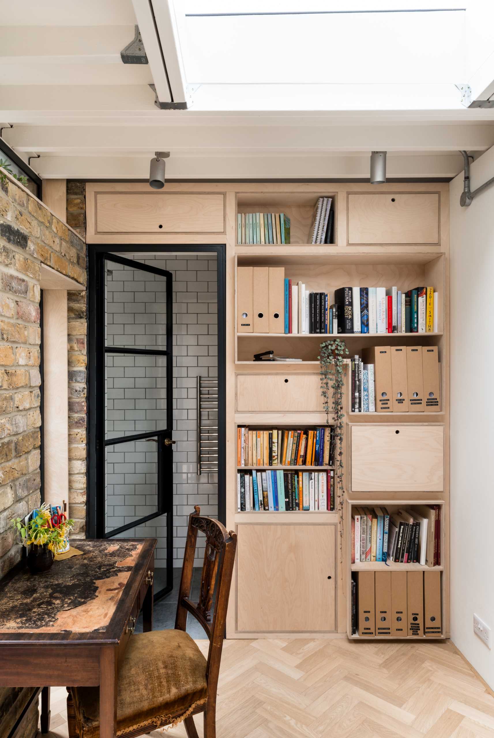 A new garden studio for a writer that includes a green roof, sitting area, built-in shelving, and a bathroom.