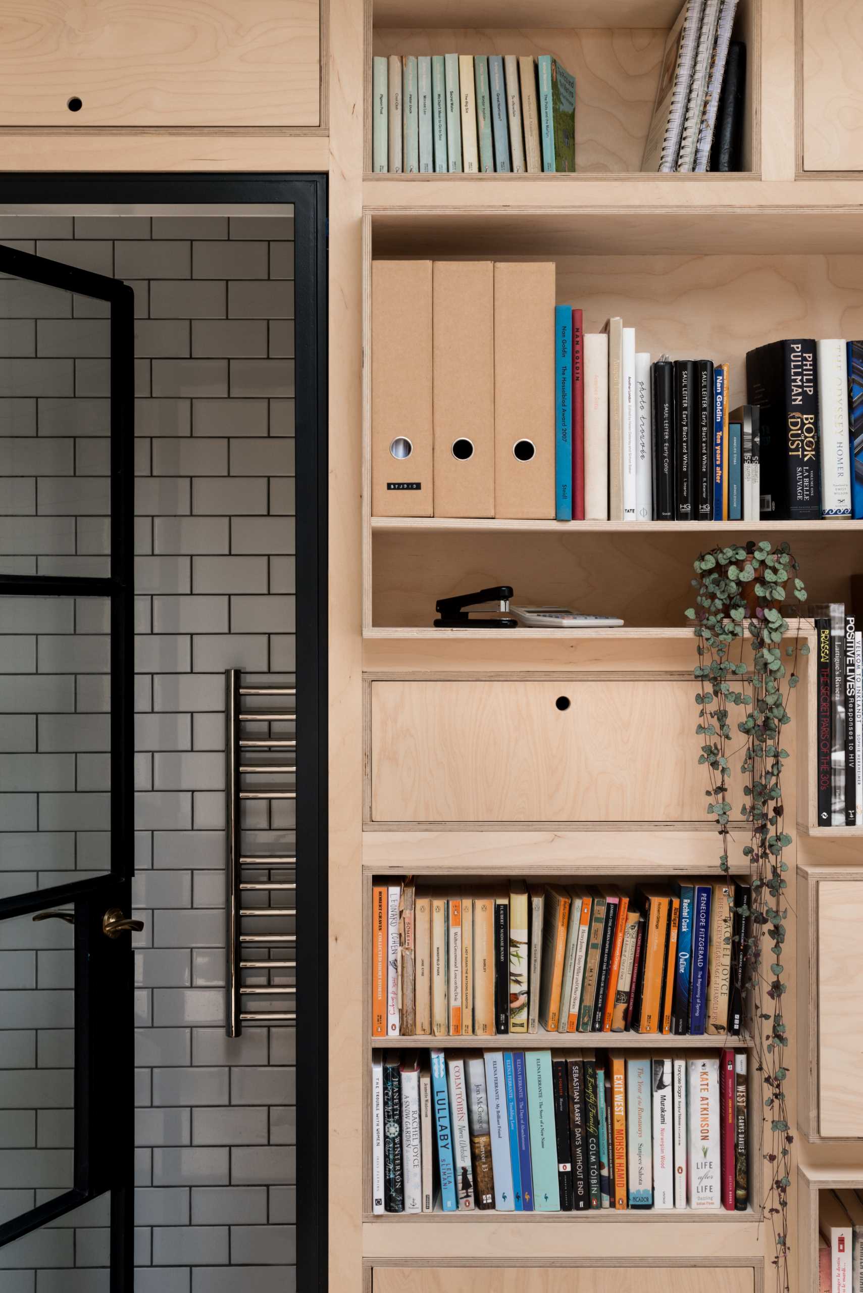 A new garden studio for a writer that includes a green roof, sitting area, built-in shelving, and a bathroom.