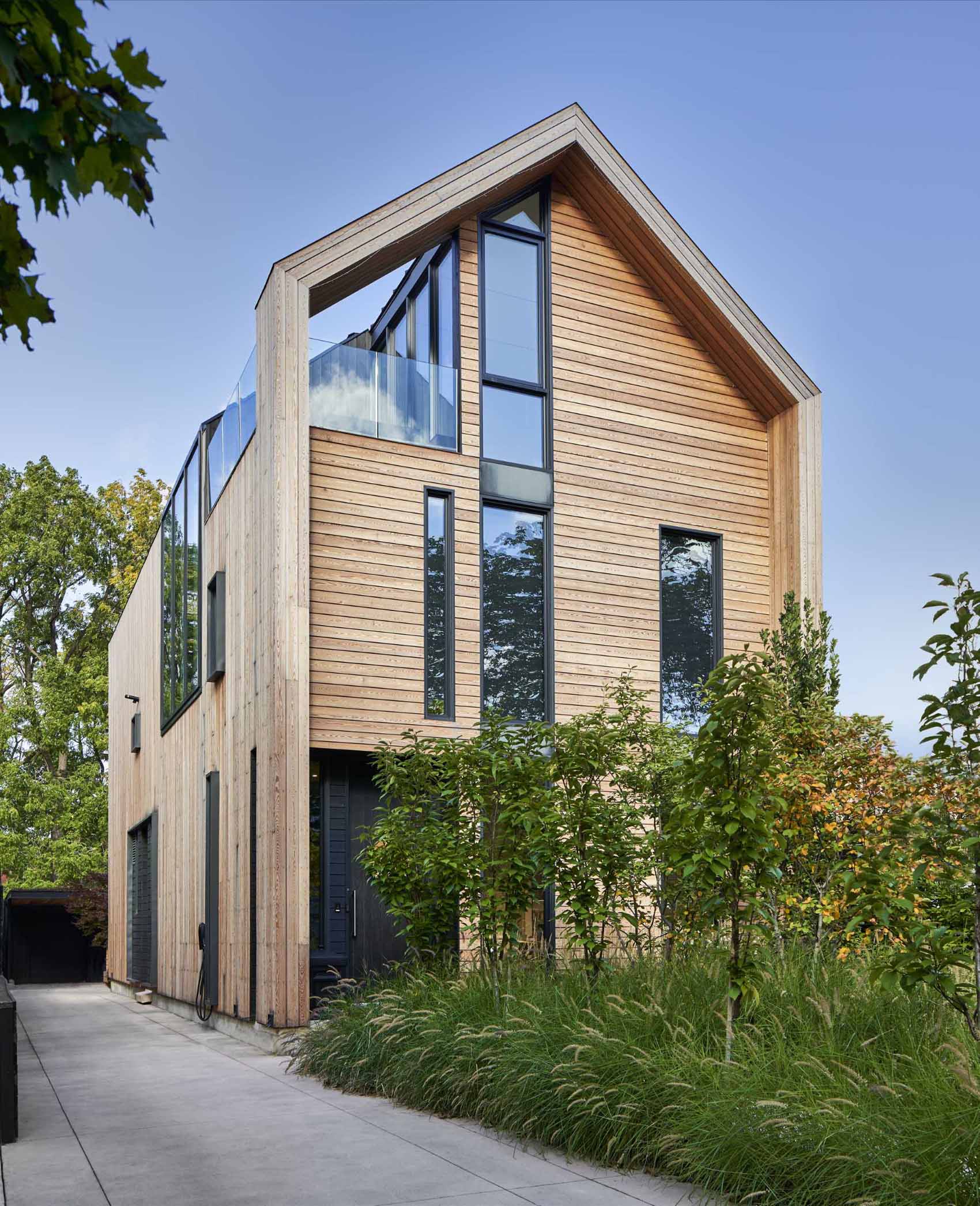 This home is clad in pre-treated kiln-dried wood siding to exude warmth and texture, while a prefinished standing seam metal roof adds a contemporary element. 