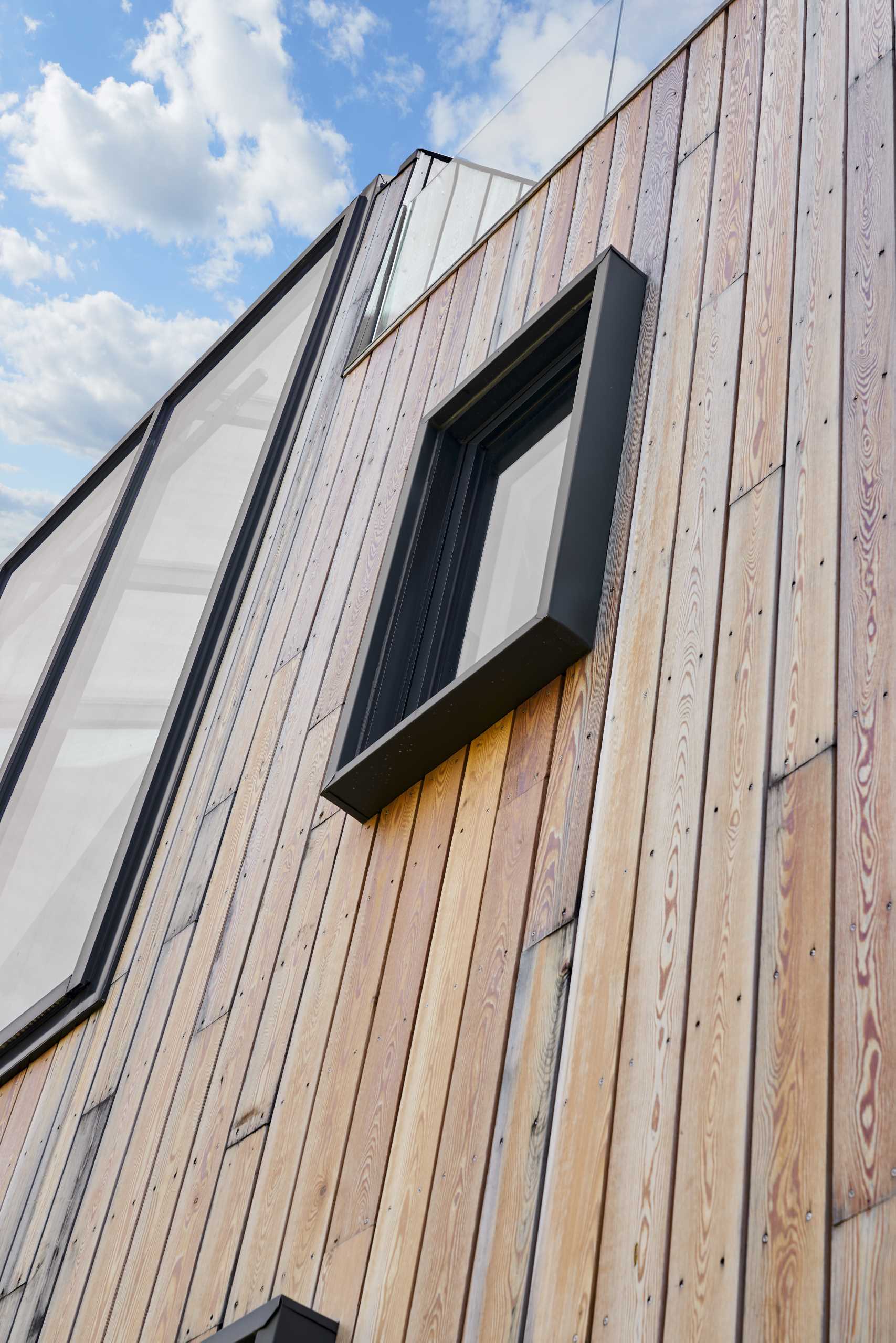 This home is clad in pre-treated kiln-dried wood siding to exude warmth and texture, while a prefinished standing seam metal roof adds a contemporary element. 