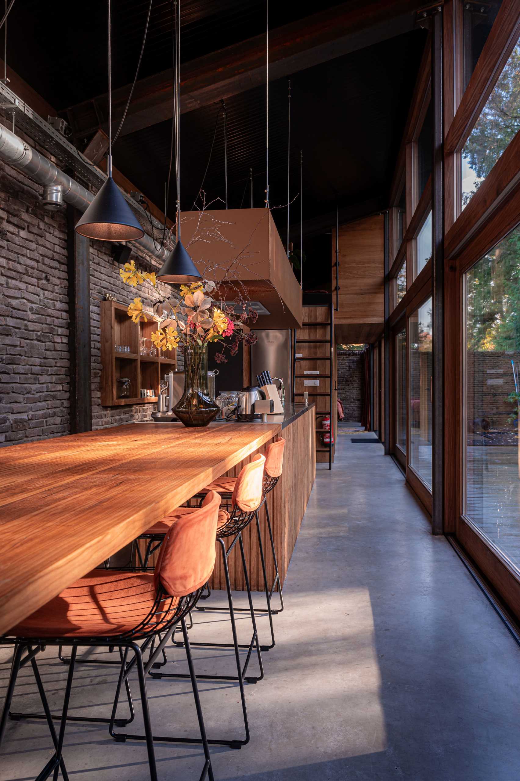 A modern kitchen with a wood bar.