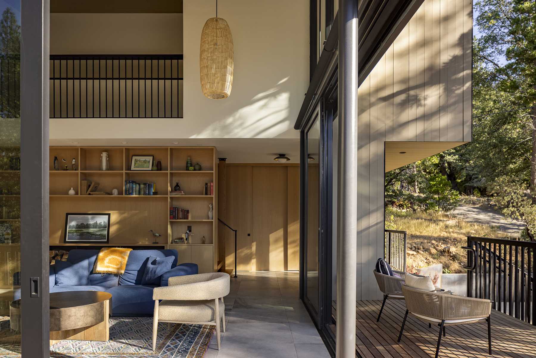 Large sliding glass doors slide open to allow the living room to connect with the deck, creating an indoor/outdoor living experience. 