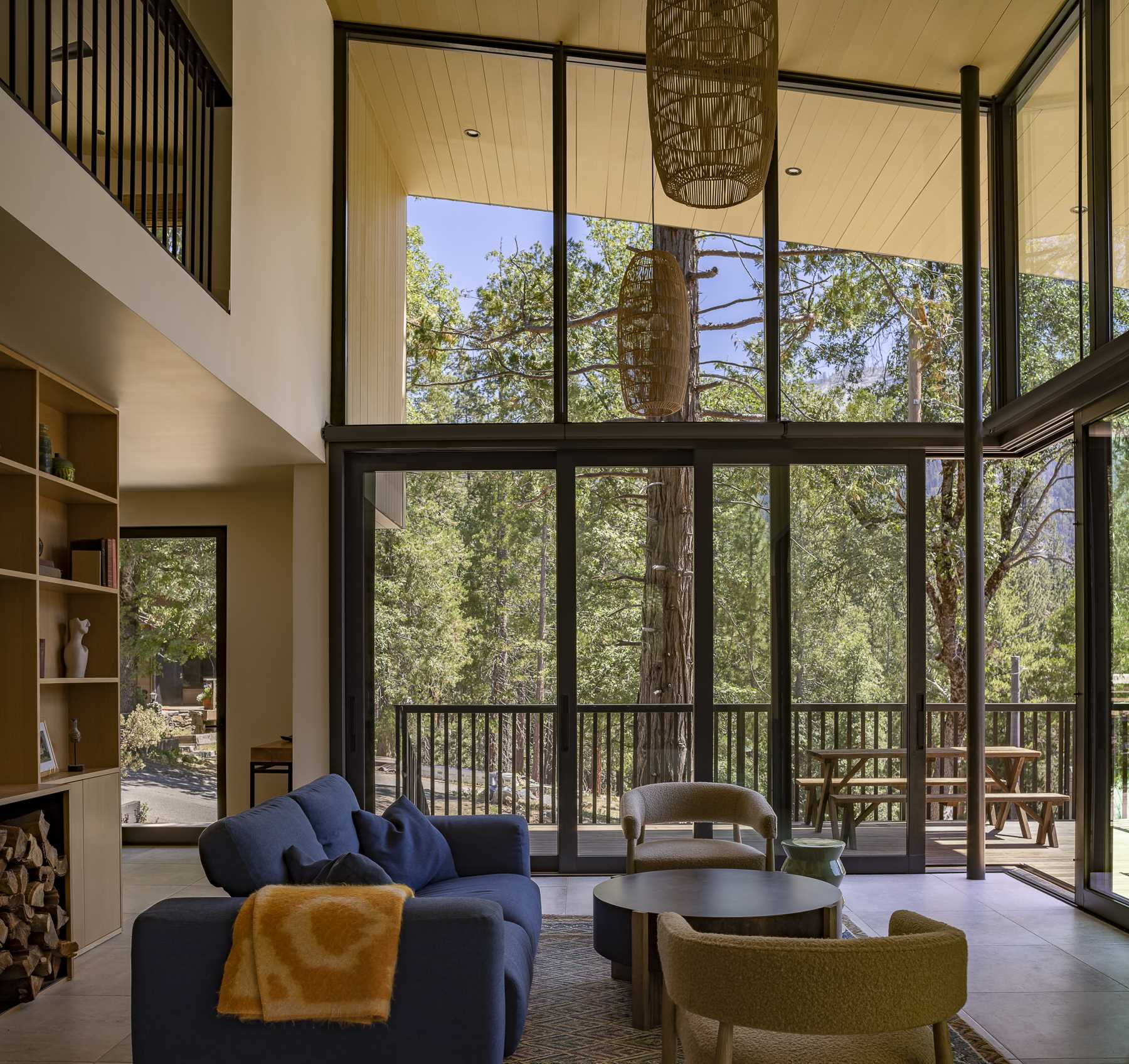 The double-height ceiling makes the space feel much larger than it is, and the walls of windows flood the interior with an abundance of natural light.