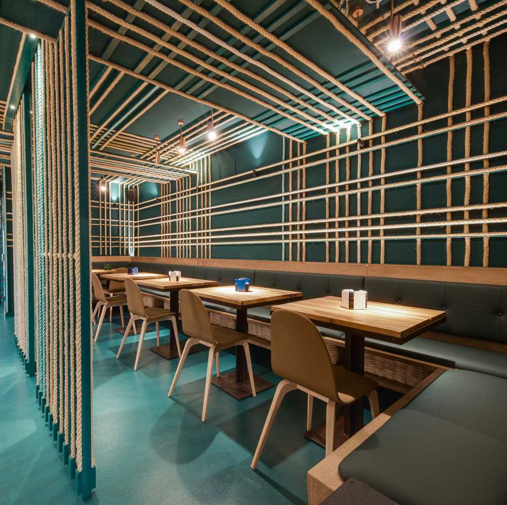 A seaside inspired restaurant included a seating area where ropes have been used as part of the design.