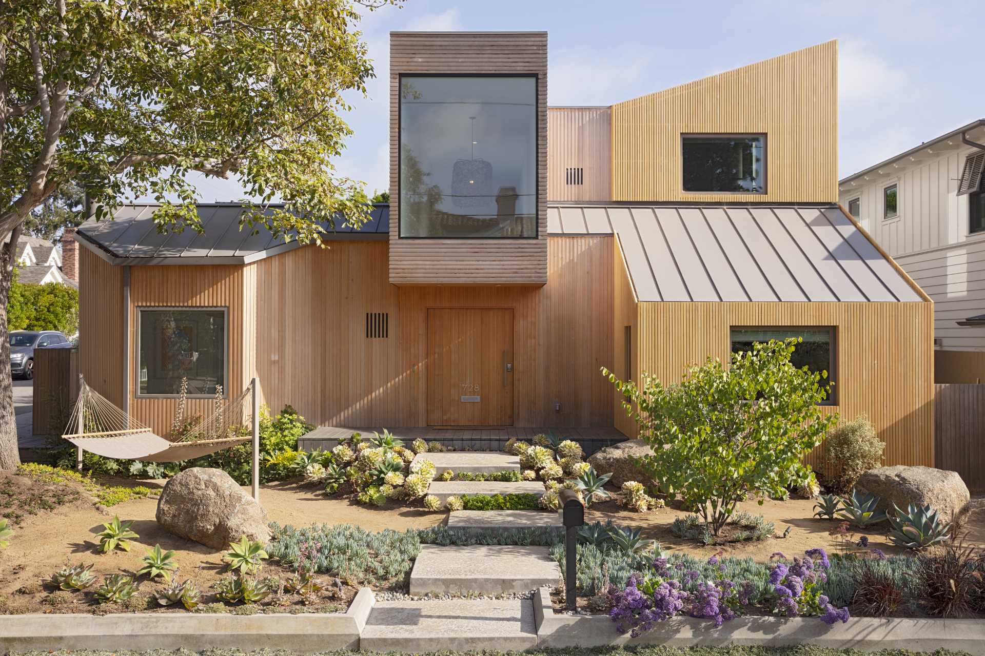 The custom-milled siding of this modern house is Alaskan yellow cedar and was chosen specifically for how it will weather over time, graying out to create a rustic patina reminiscent of the Sea Ranch aesthetic.