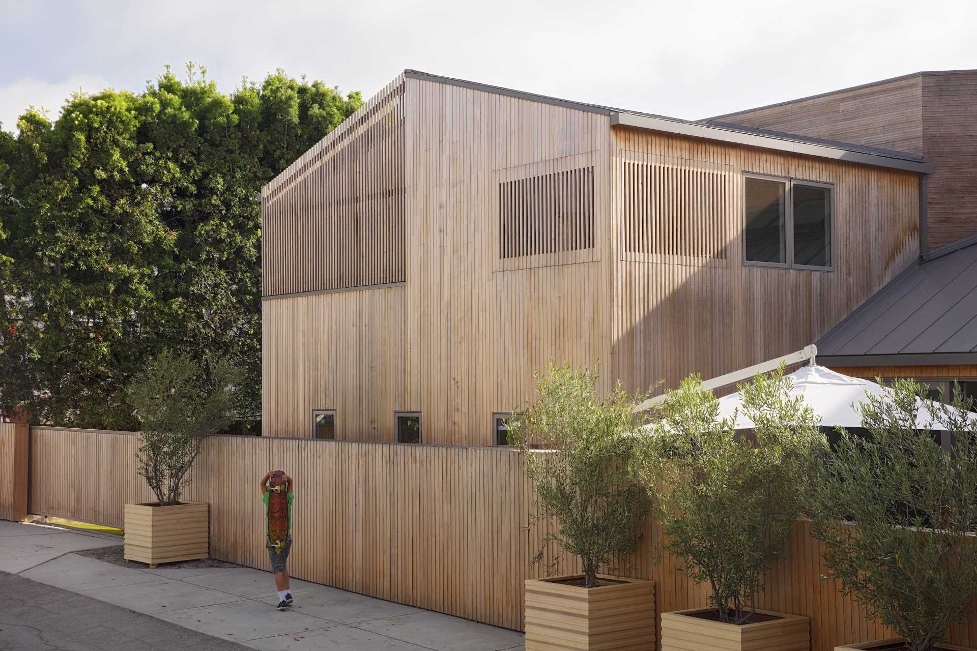 The custom-milled siding of this modern house is Alaskan yellow cedar and was chosen specifically for how it will weather over time, graying out to create a rustic patina reminiscent of the Sea Ranch aesthetic.