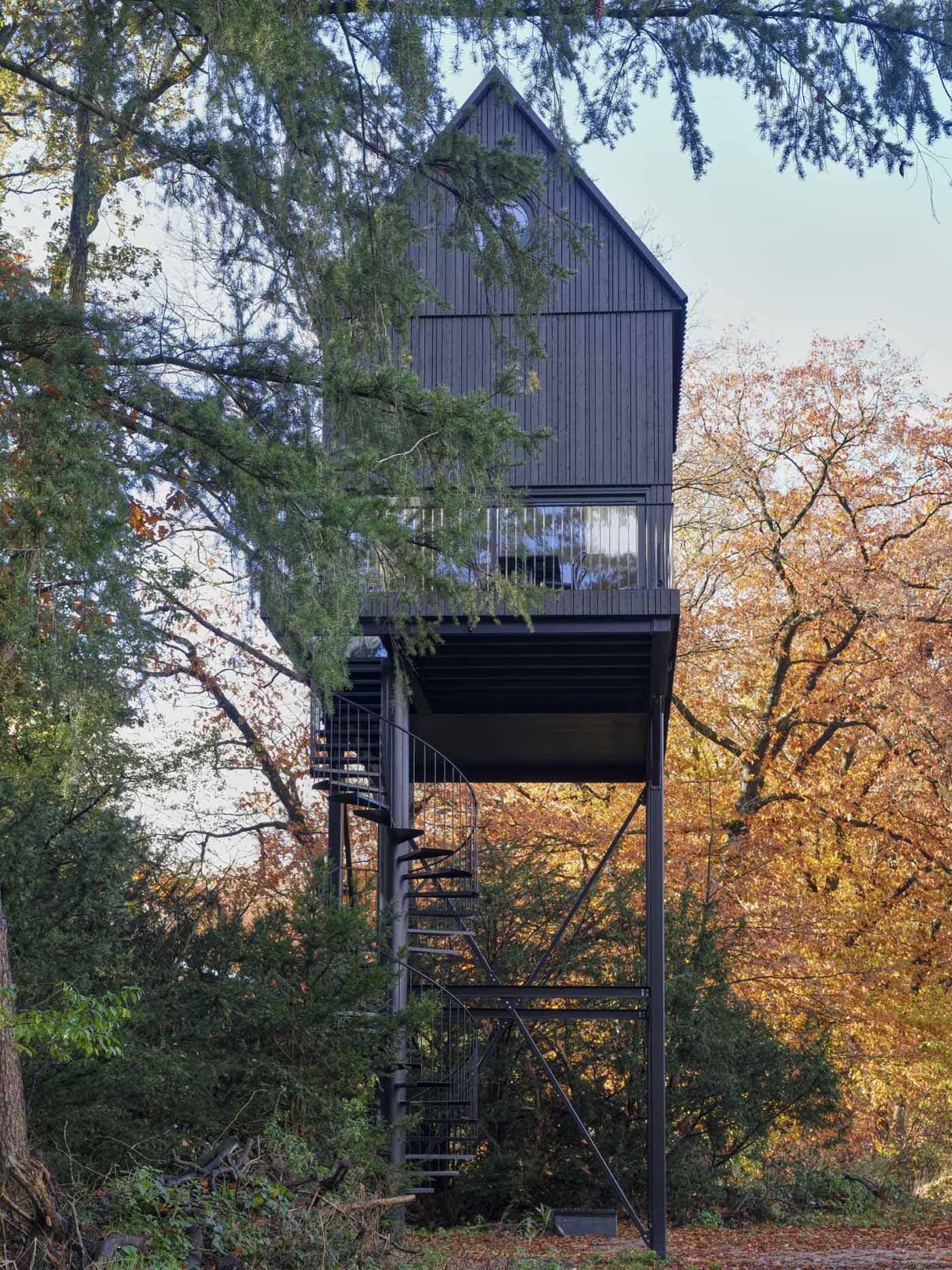 A small cabin that's designed as a multi-level elevated bird house.