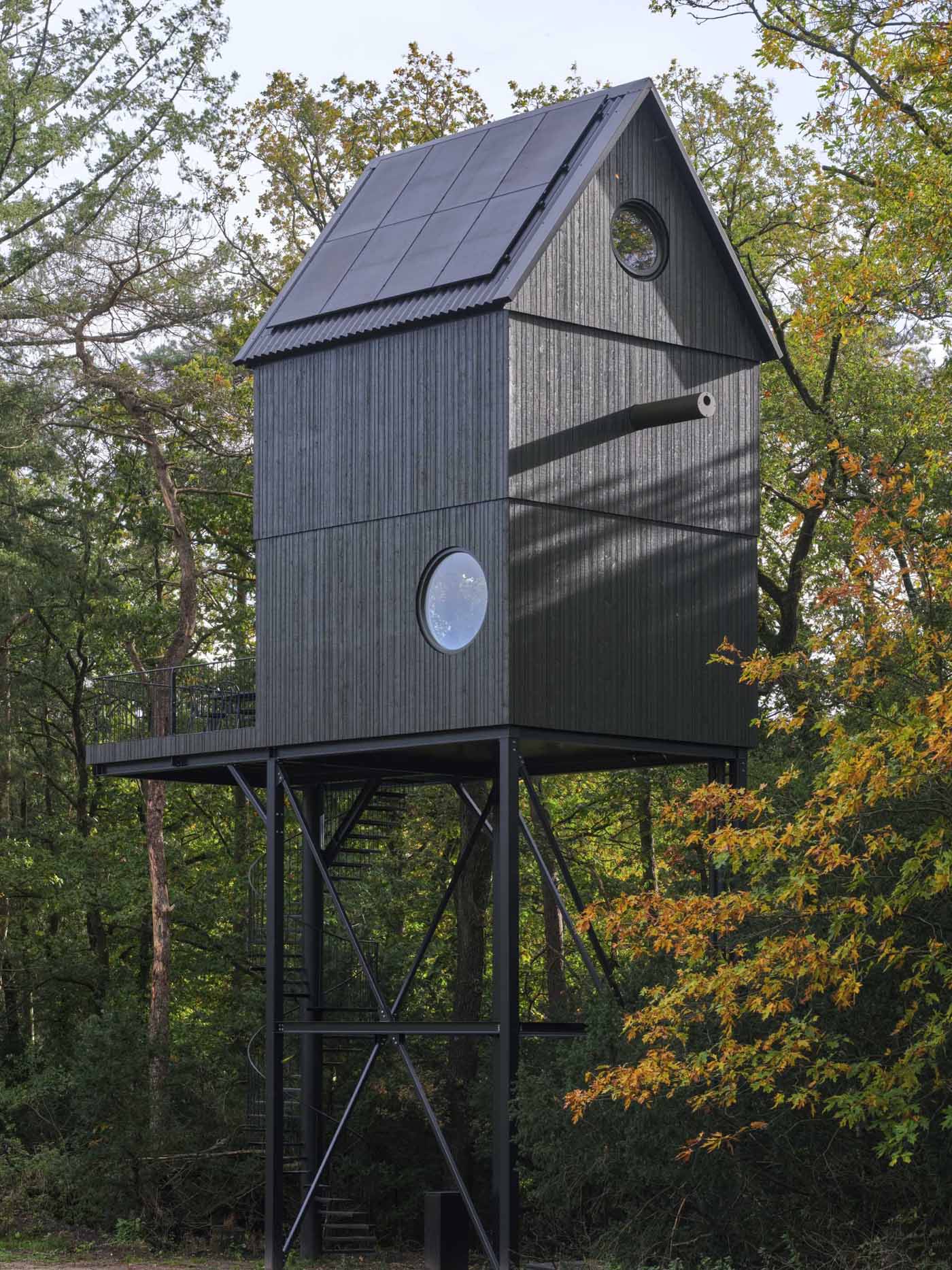A small cabin that's designed as a multi-level elevated bird house.