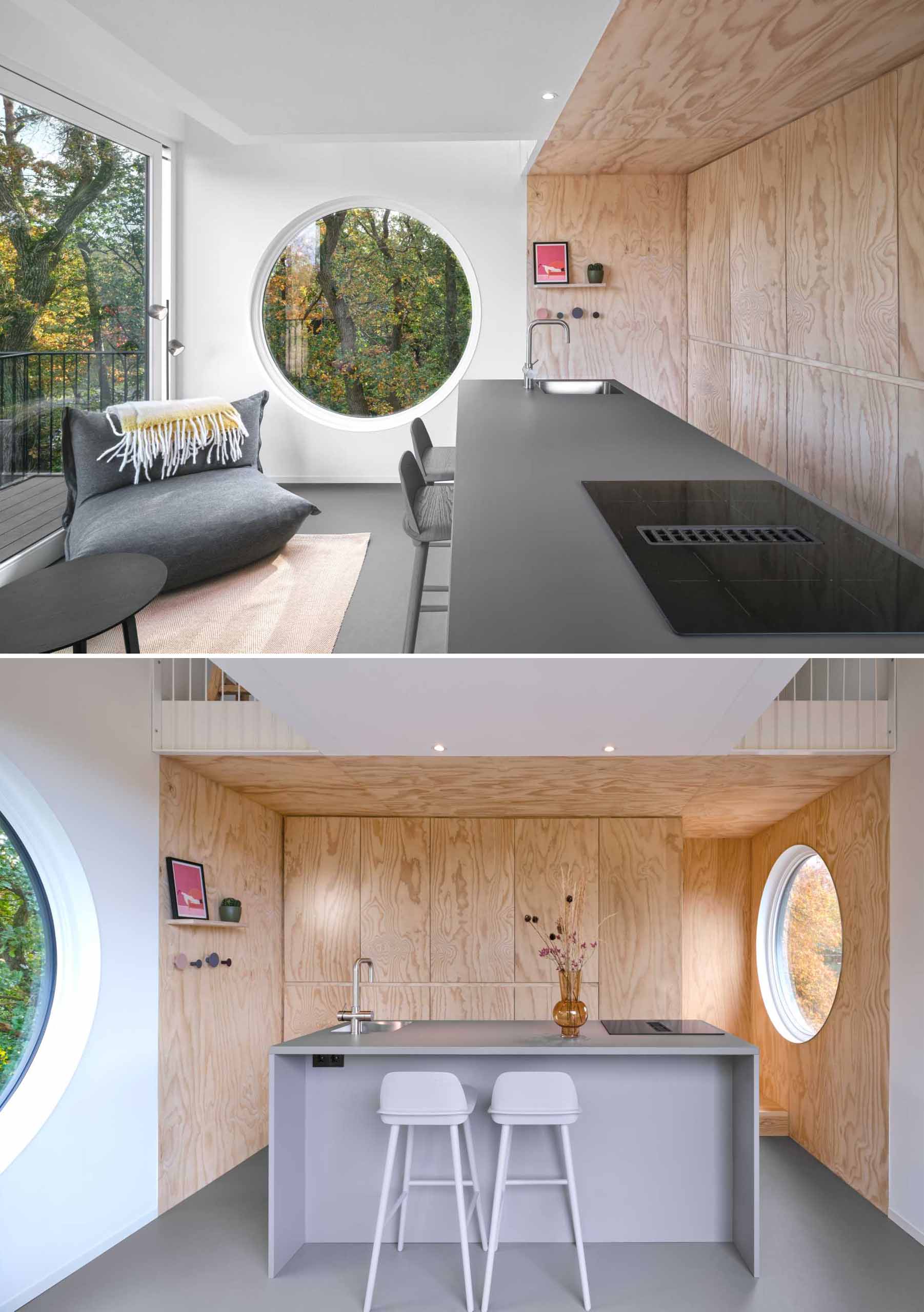 The living room and kitchen of a small elevated cabin.