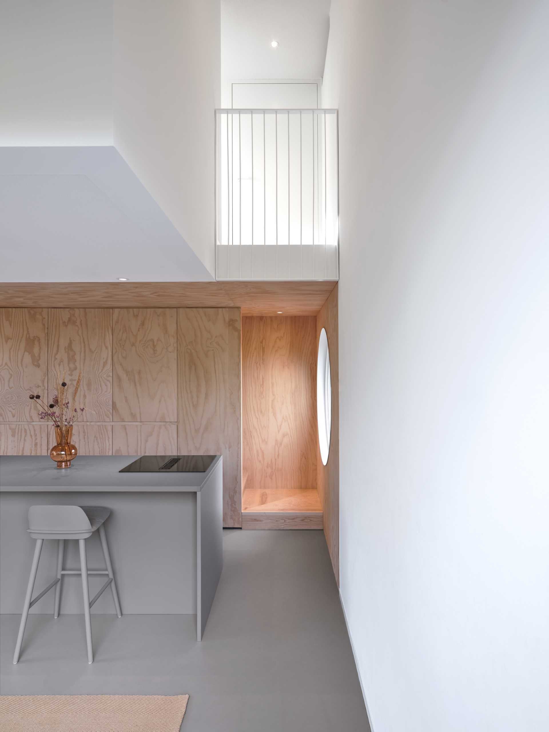 The living room and kitchen of a small elevated cabin.