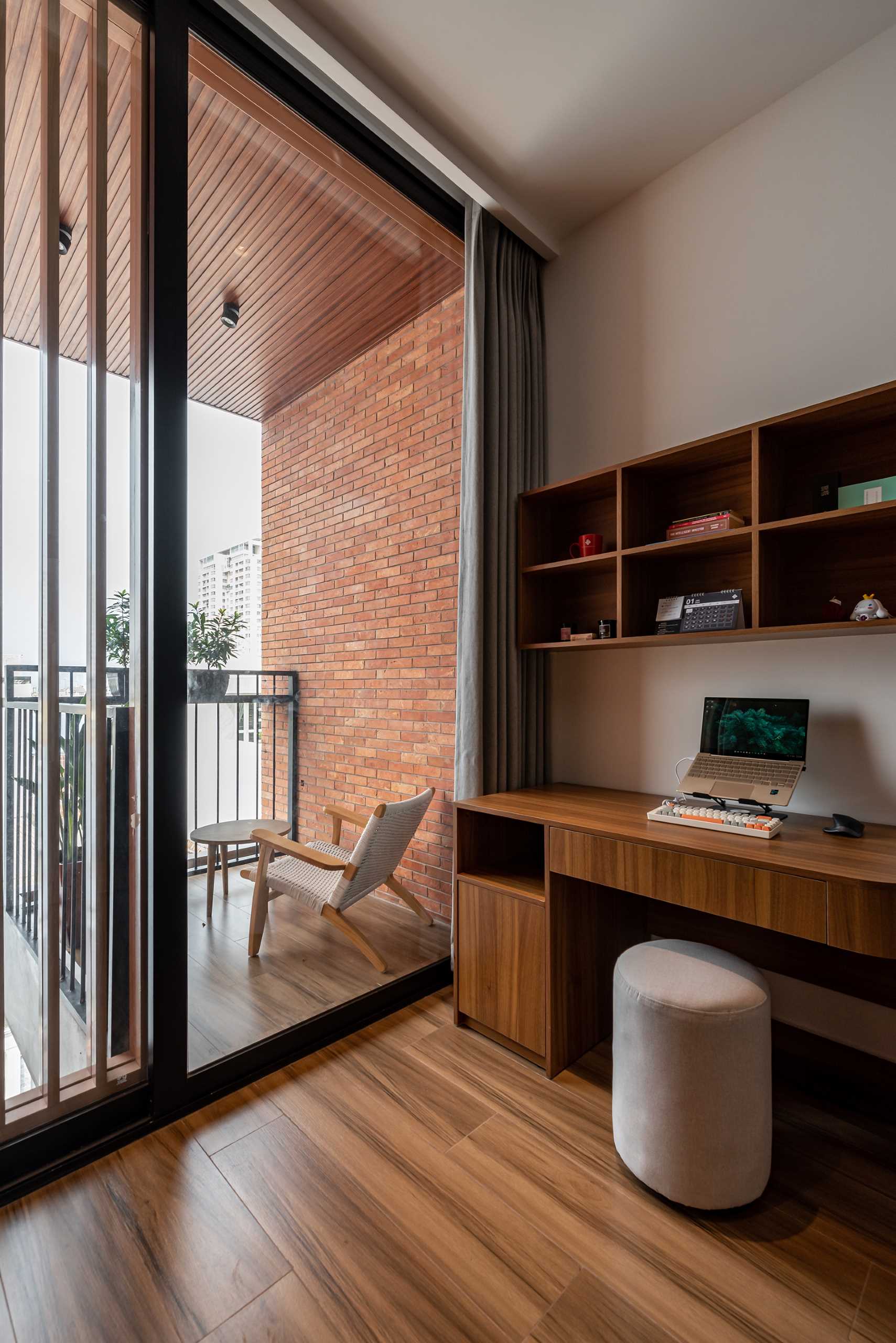 A modern bedroom with a glass-enclosed bathroom and a balcony.