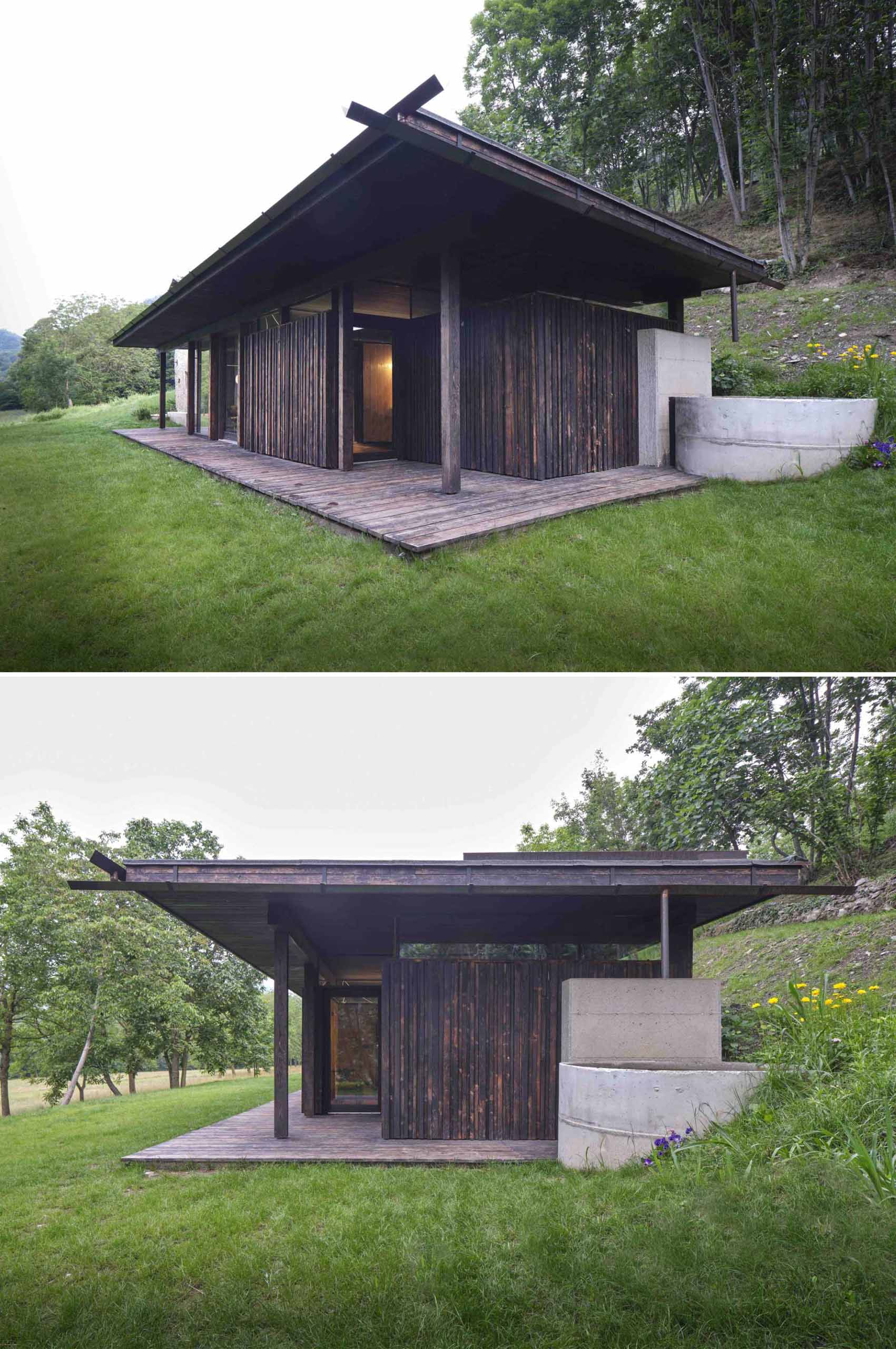 An abandoned stone ruin that was once overgrown with brambles, has been transformed into a small off-grid home with burnt larch wood and large windows.