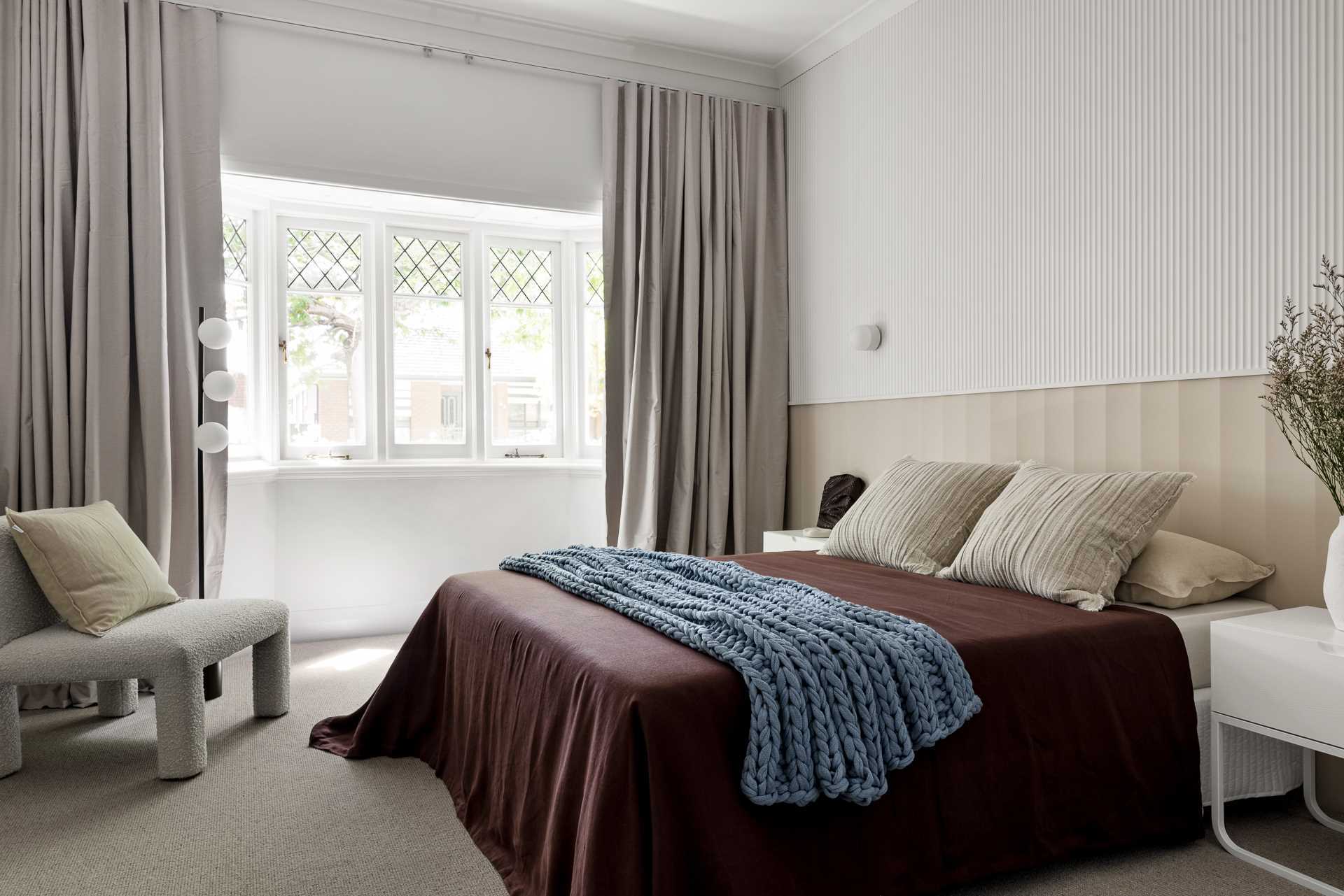 In this bedroom, a textured wall has been added to create visual interest.