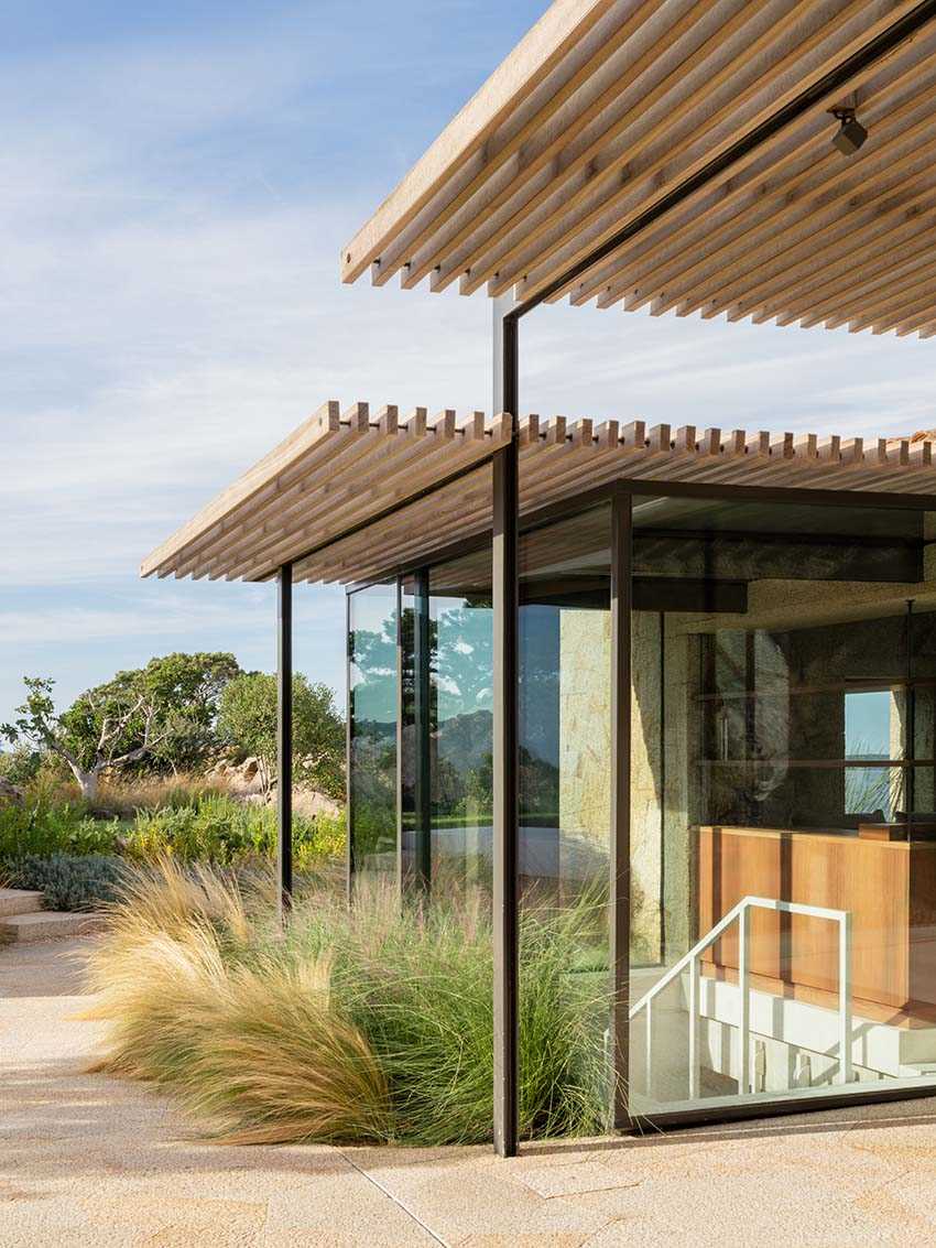 Glass walls, with some that open, connect the outdoor spaces to the interior, while at the same time, providing unobstructed water views.