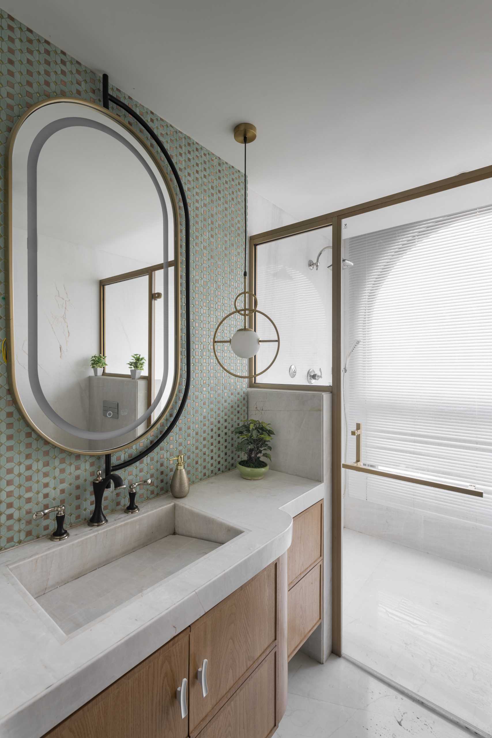 A contemporary bathroom with gold accents.