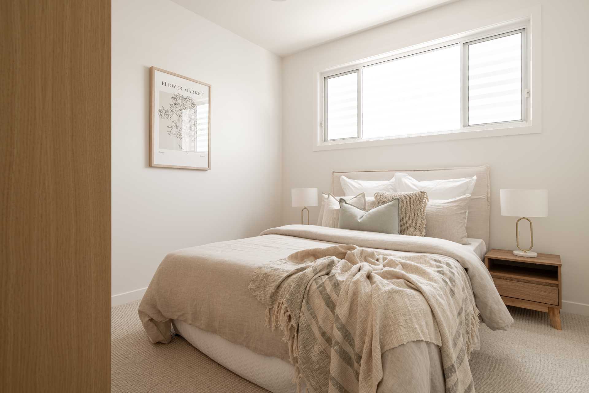 A contemporary bedroom with a neutral color palette.