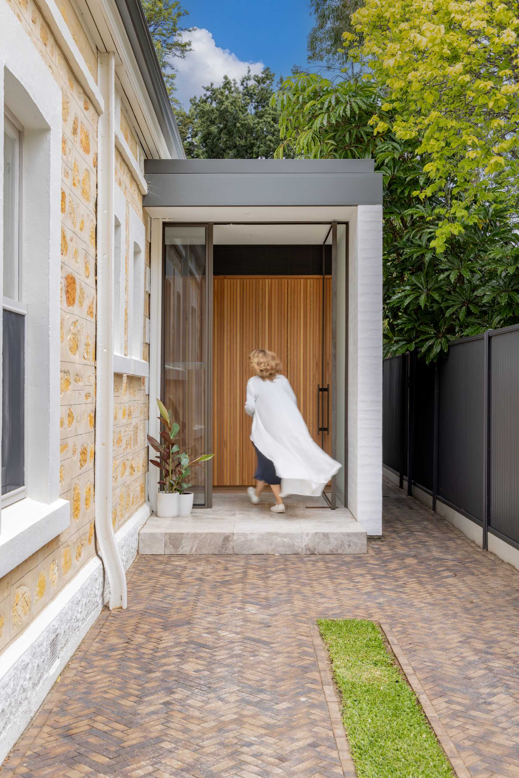 The extension can be accessed through the front door of the home, or via a side door off the driveway.