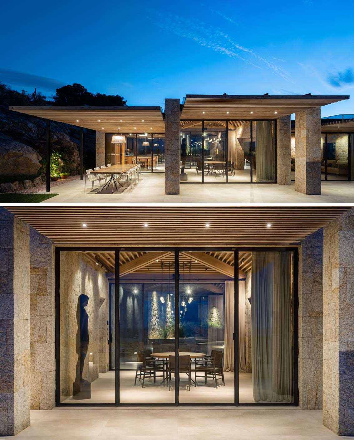 Here's a look at the home at nighttime with exterior lights highlighting the stone and design of the house.