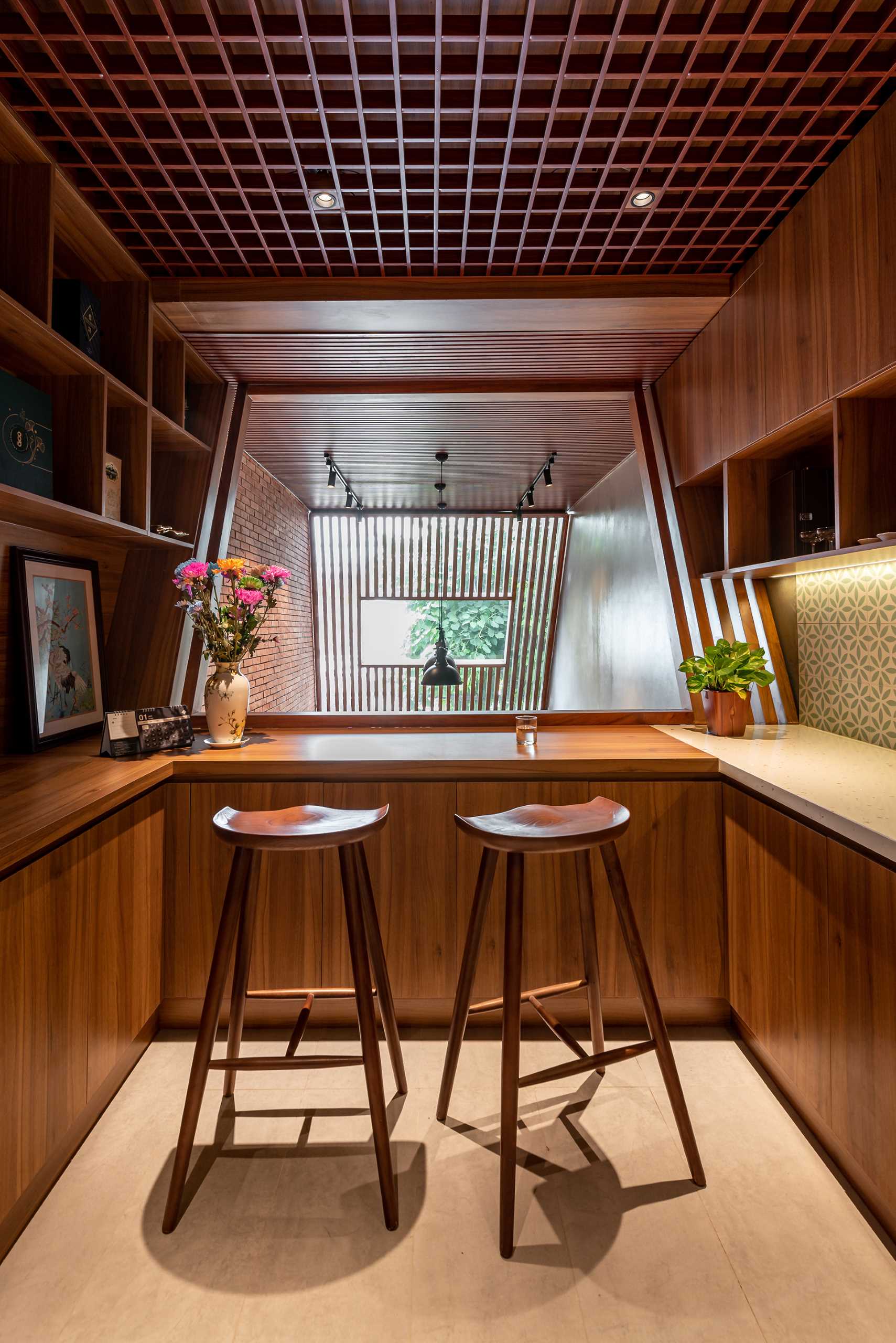 The mezzanine of this tall and skinny house, is home to the dining area and kitchen, has a skylight that can look down into the garage area and entrance hall so you can cook and look after the house at the same time.