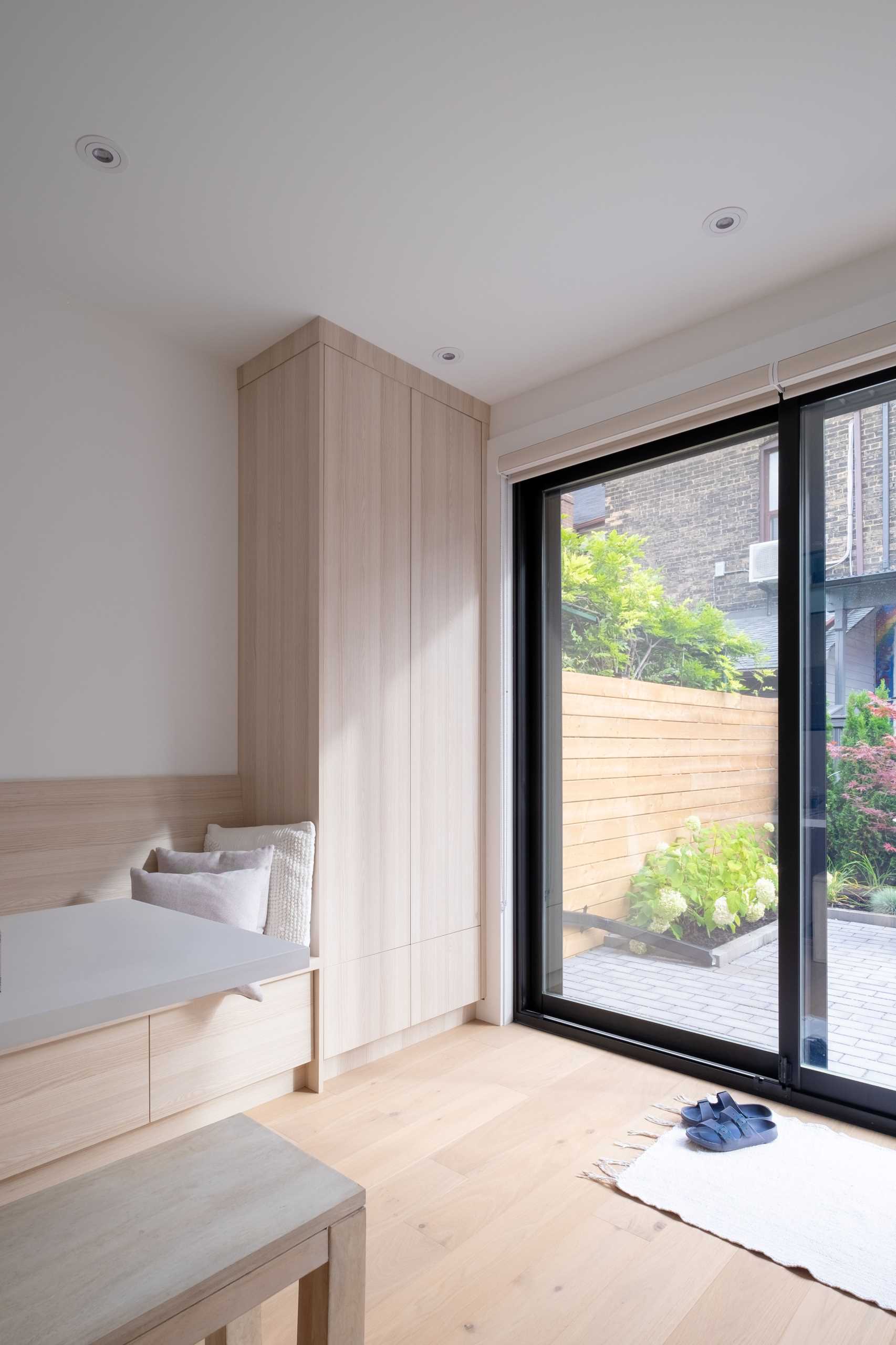 A laneway house with a small dining area that includes banquette seating to save space.