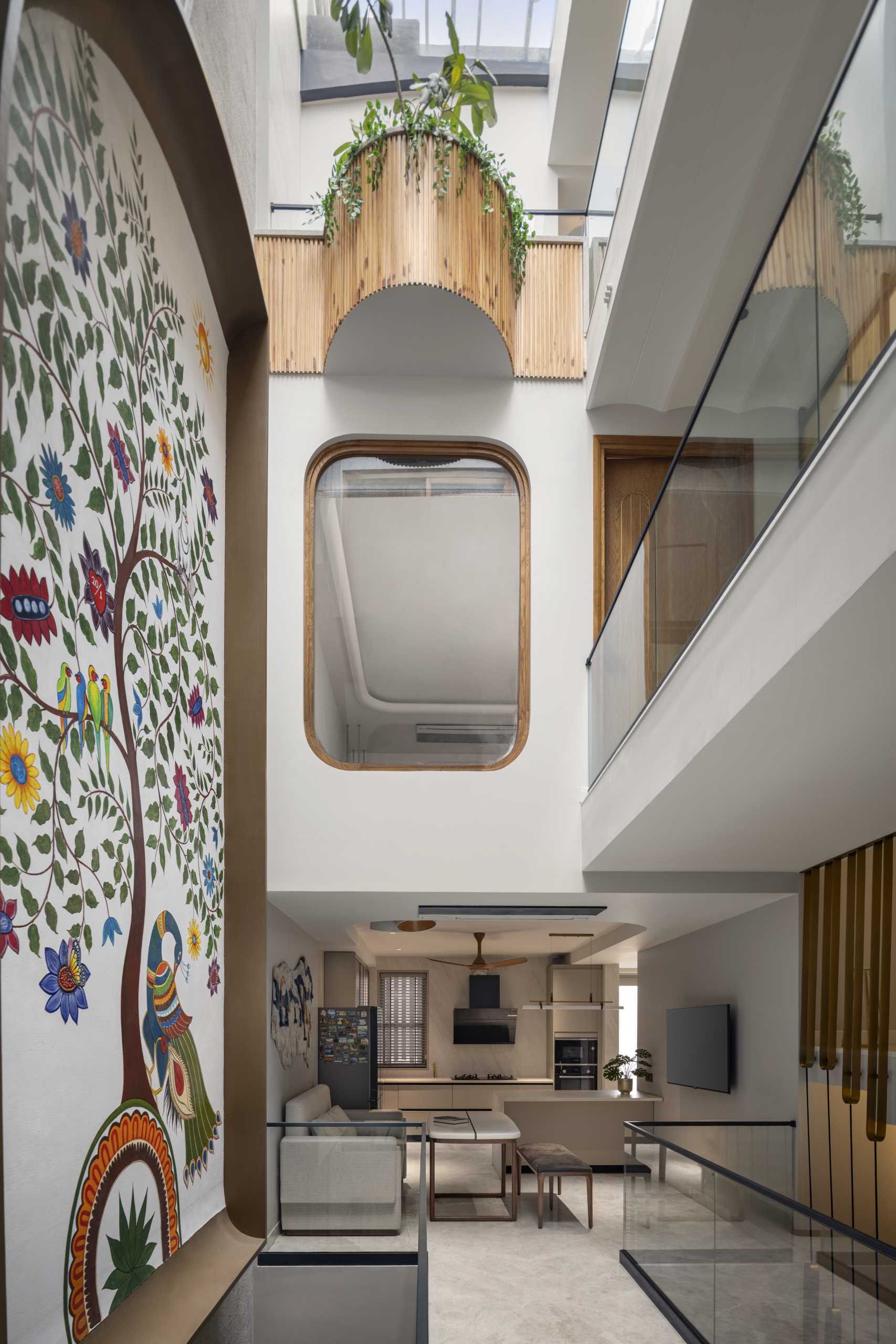 A tall and narrow house with a large colorful wall mural.