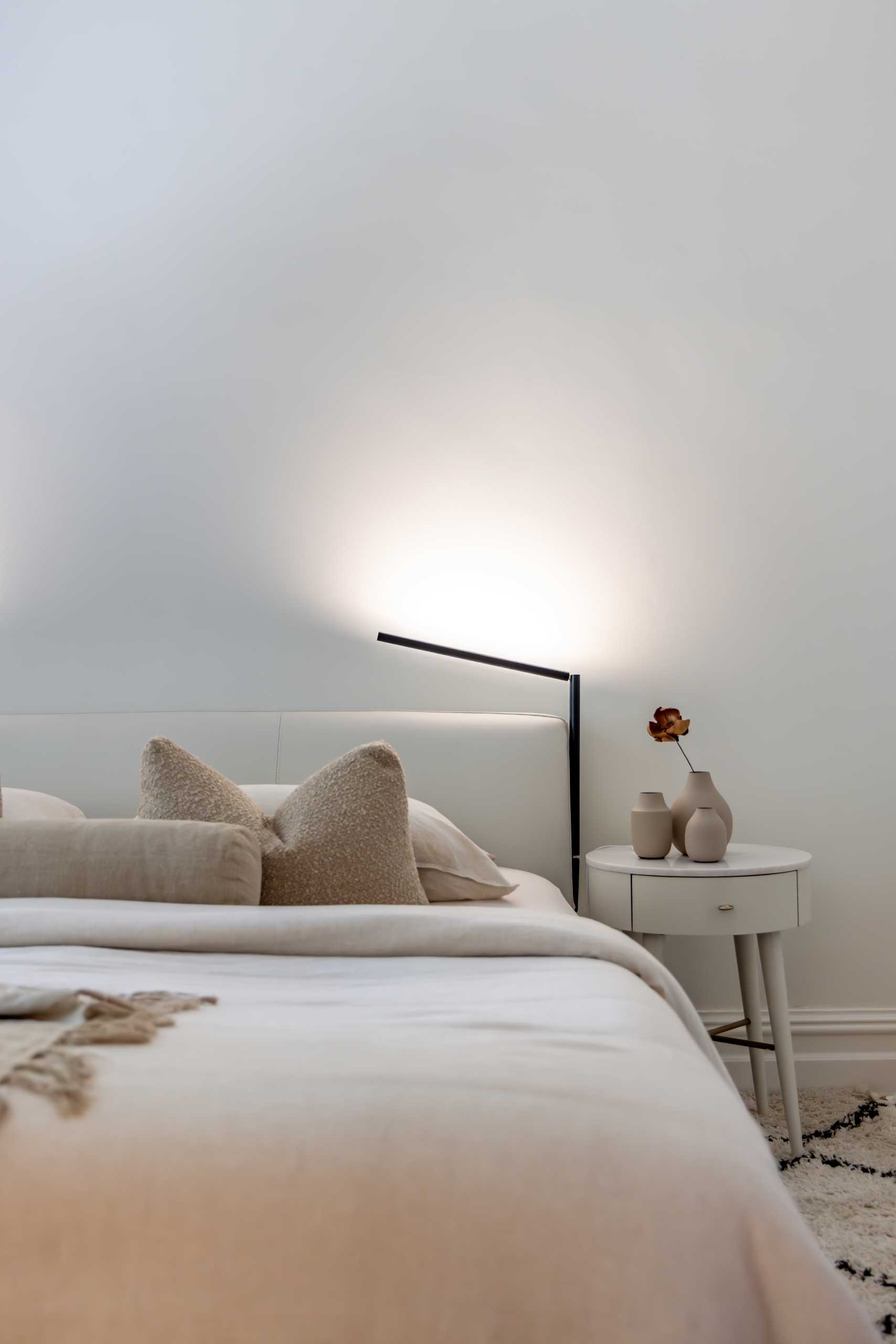 A minimalist design was chosen for the bedroom, with neutral furnishings and color palette.