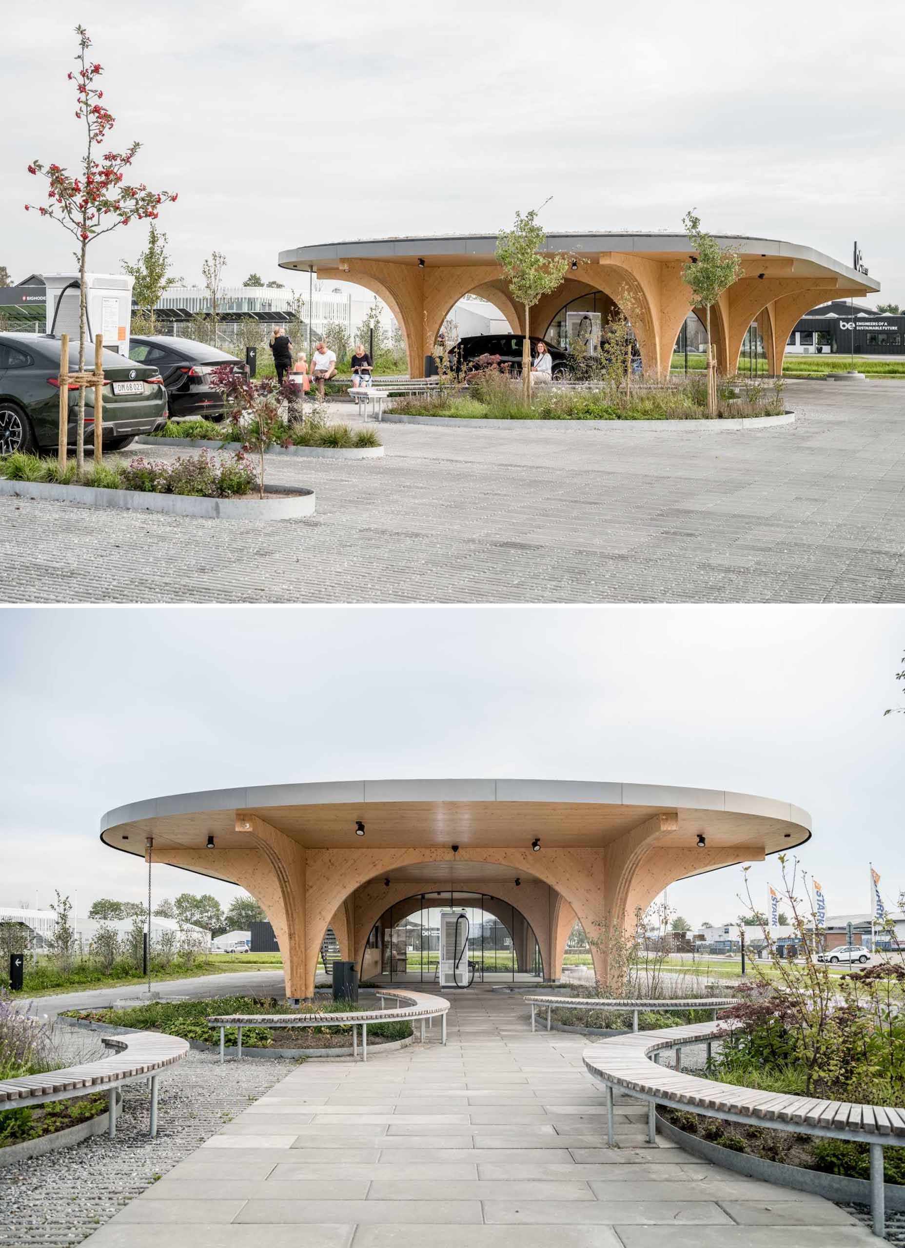 A contemporary charging park features an exposed wood structure and a park with native plants.