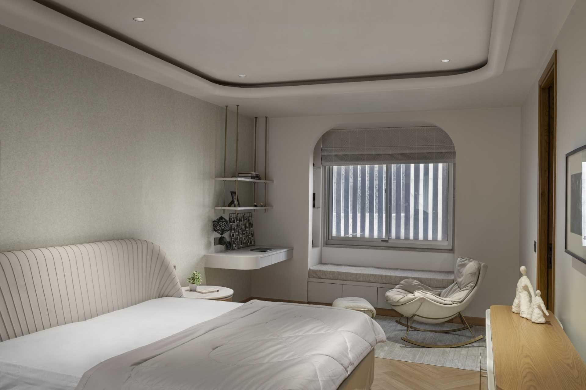 A contemporary bedroom with a floating desk and window seat.